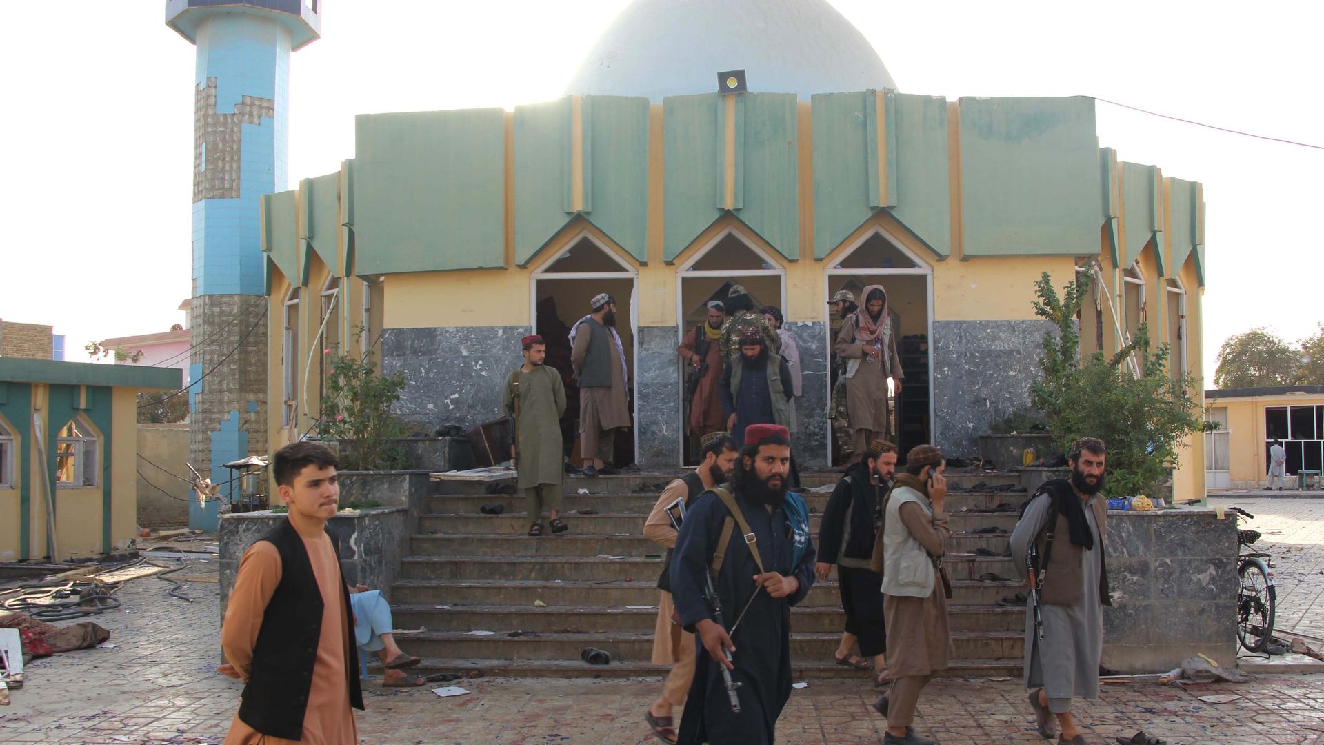 Afghan Taliban members inspect the site of an explosion at a mosque in Kunduz city, northern Afghanistan, Oct. 8, 2021.