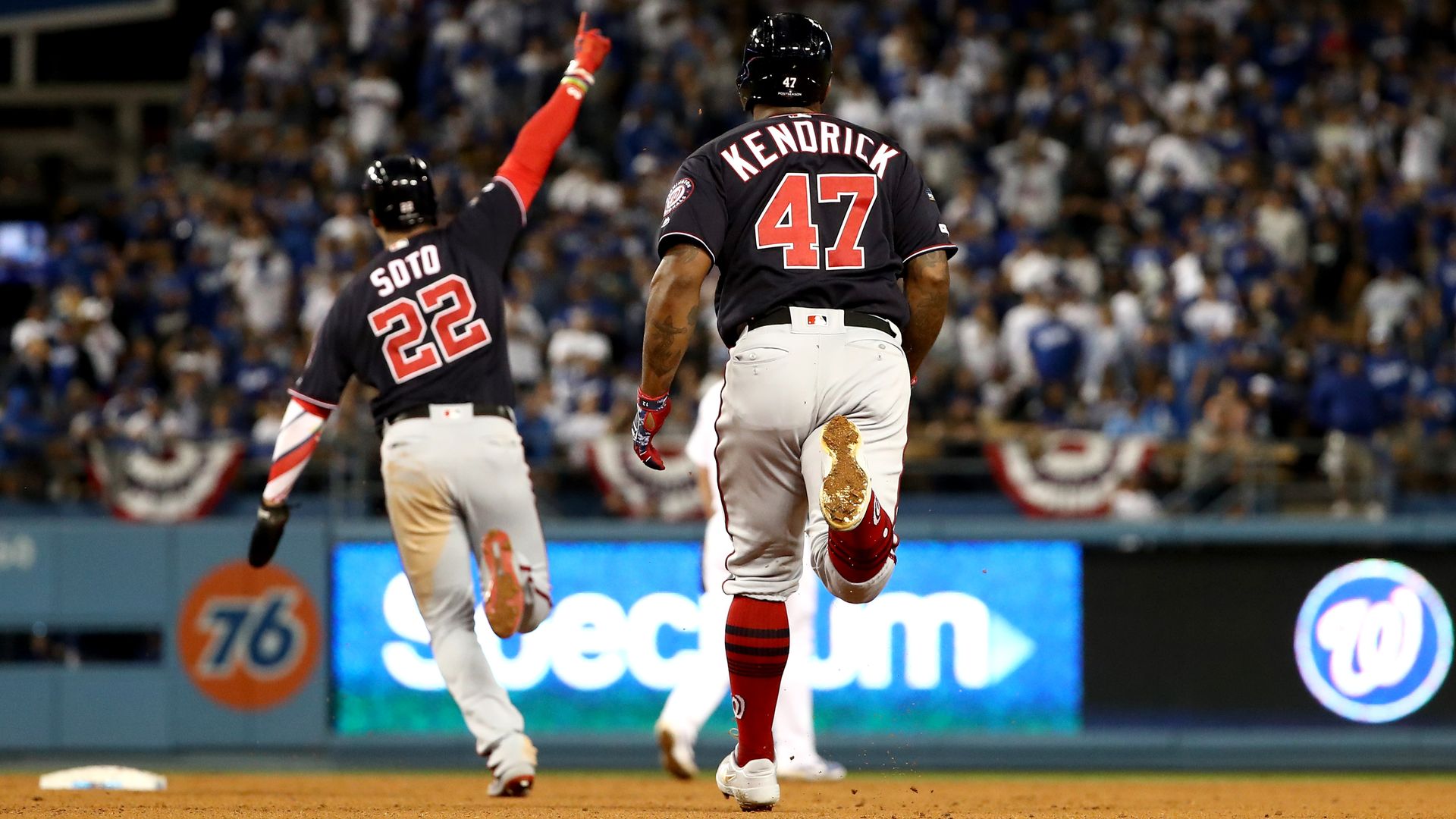 Juan Soto and Howie Kendrick rounding the bases