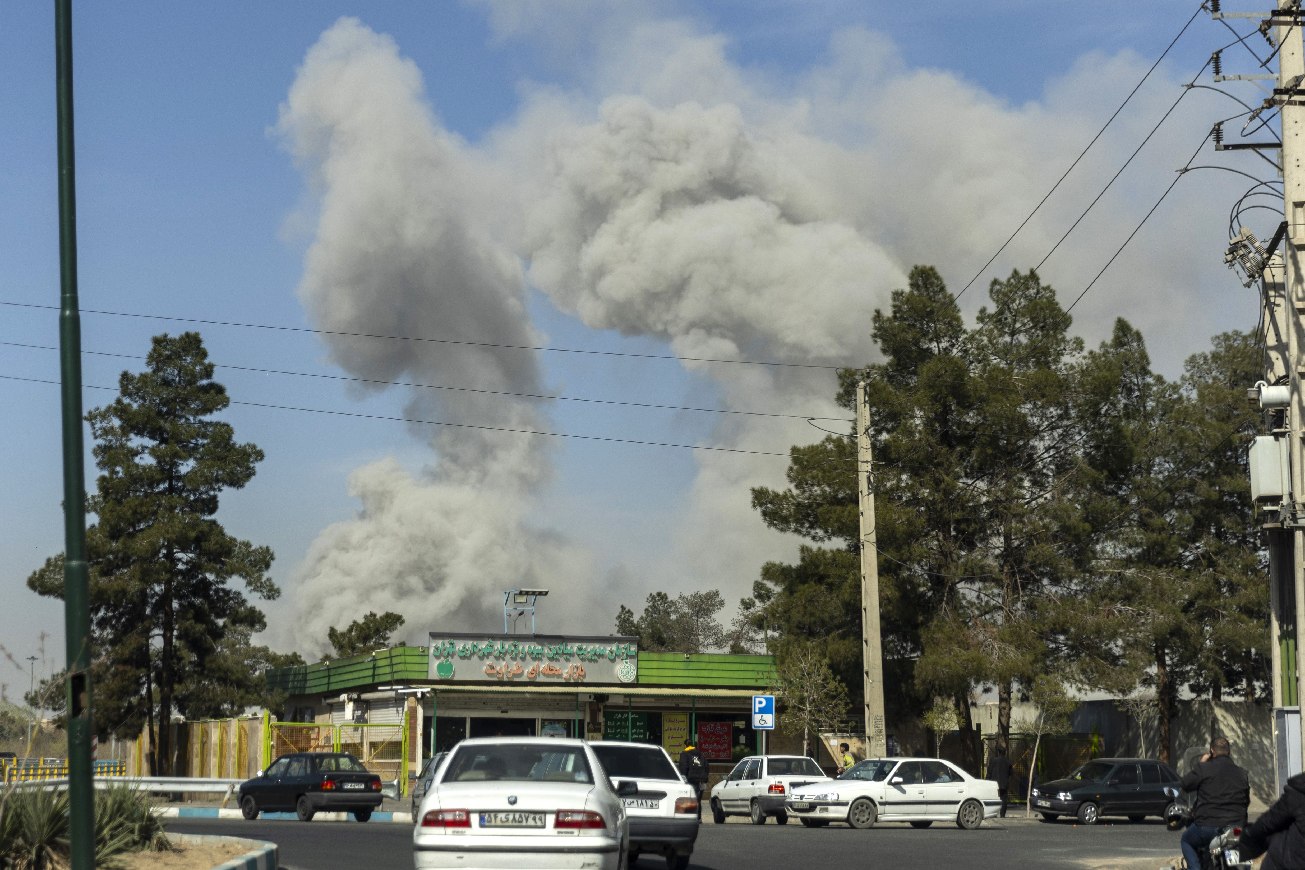 Thick plumes of smoke billow over buildings in Tehran following an explosion on March 5, 2026.