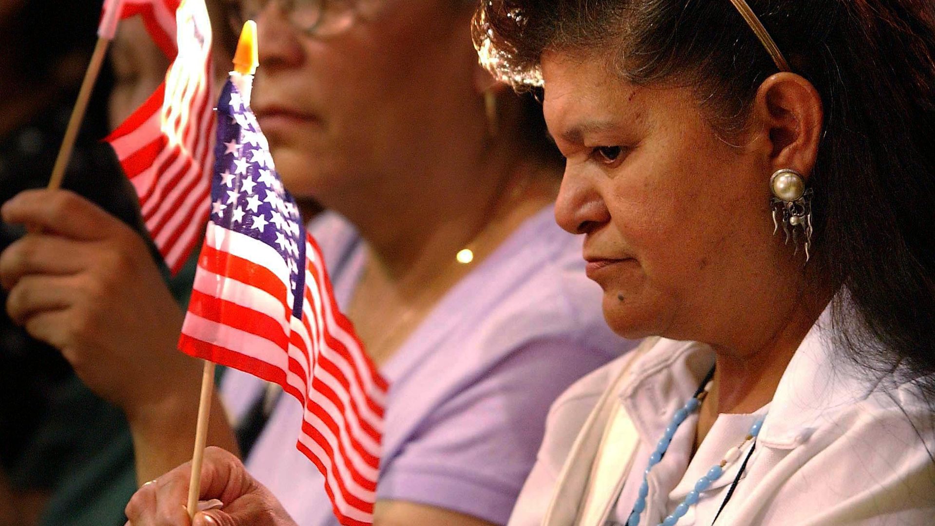 A Mexican American woman listens to a prayer 18 September 2001 in Los Angeles for immigrant workers who died in the World Trade Center one week on from the 11 September terrorist attacks on the U.S. 