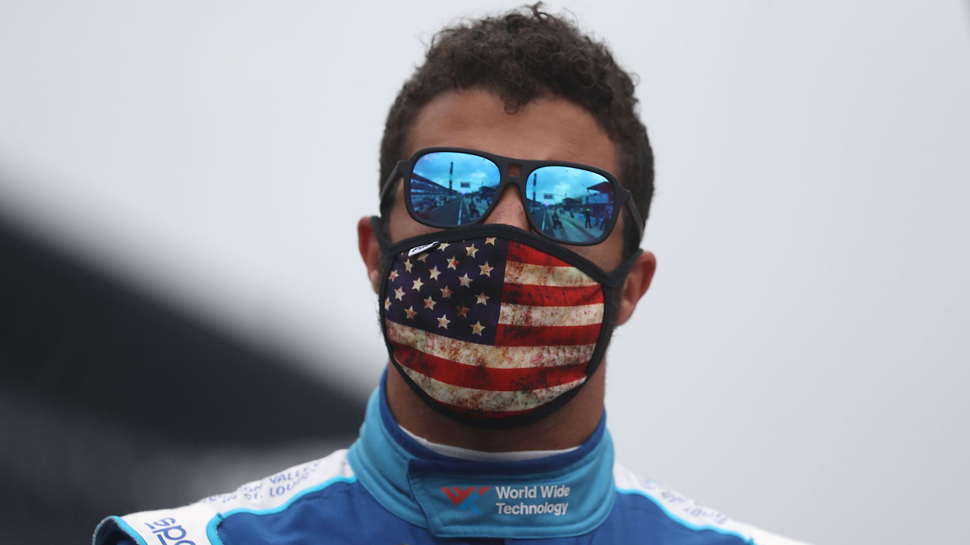 Bubba Wallace wears a face mask with an American flag on it 