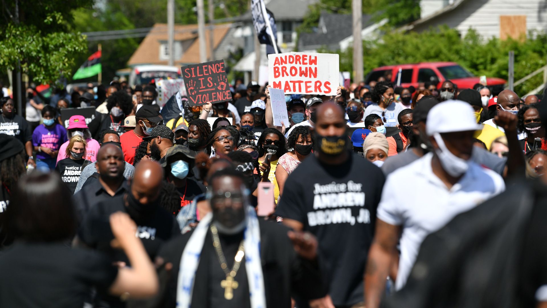Photo of a crowd of masked protesters with signs, including a white one with the text "Andrew Brown matters"