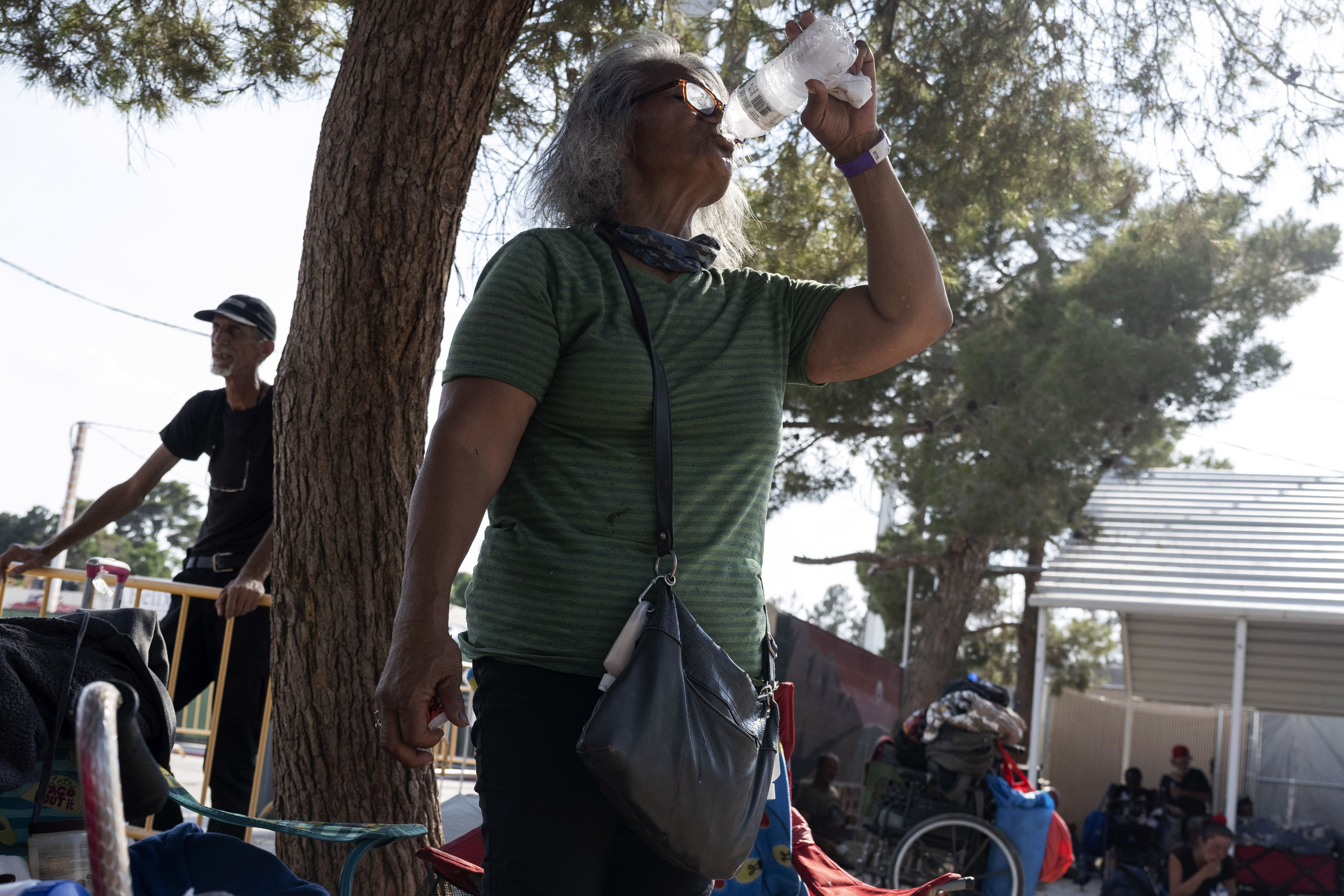 A person drinks cold water at a homeless resource center, in Las Vegas on June 16, 2021.