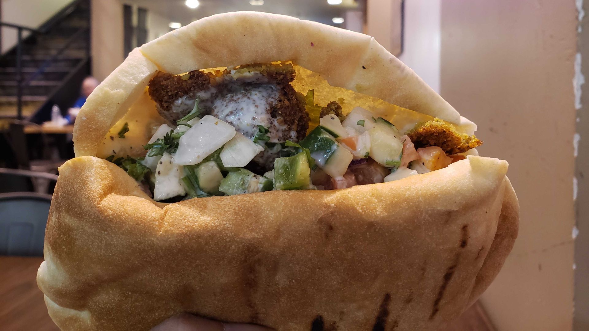 Falafel sandwich in open pita. 