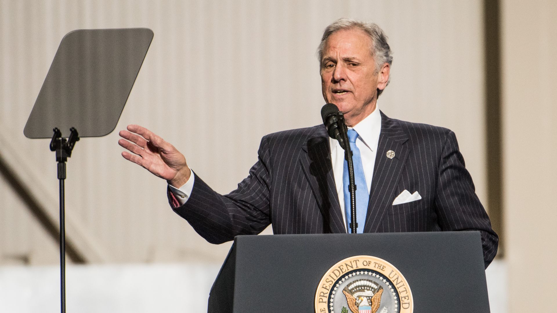 Photo of Henry McMaster speaking from a podium while waving his right hand in the air