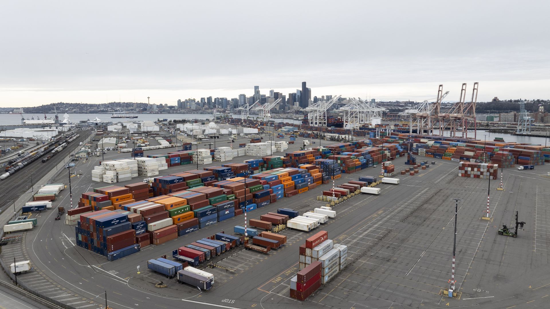 A photo of containers at the Port of Seattle with the stadium district in the background. 