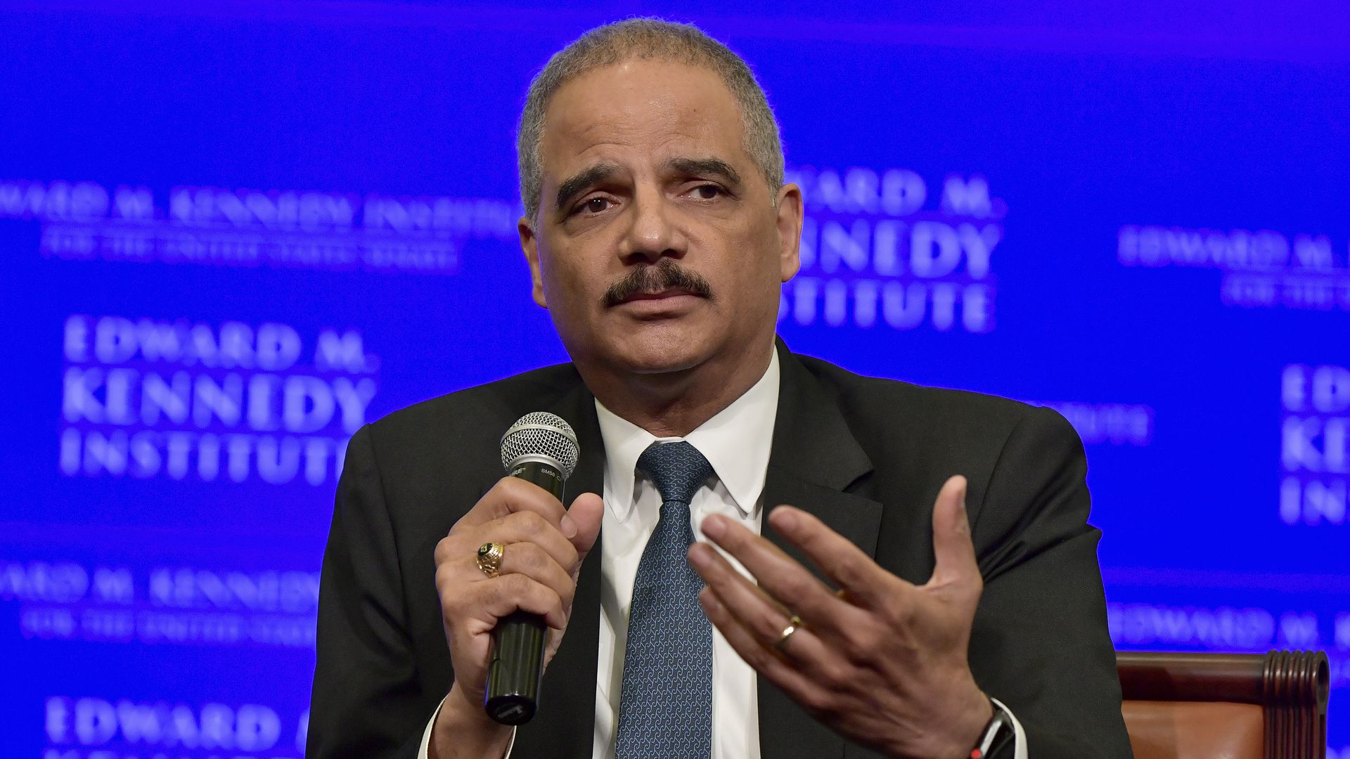 Eric Holder holding a microphone