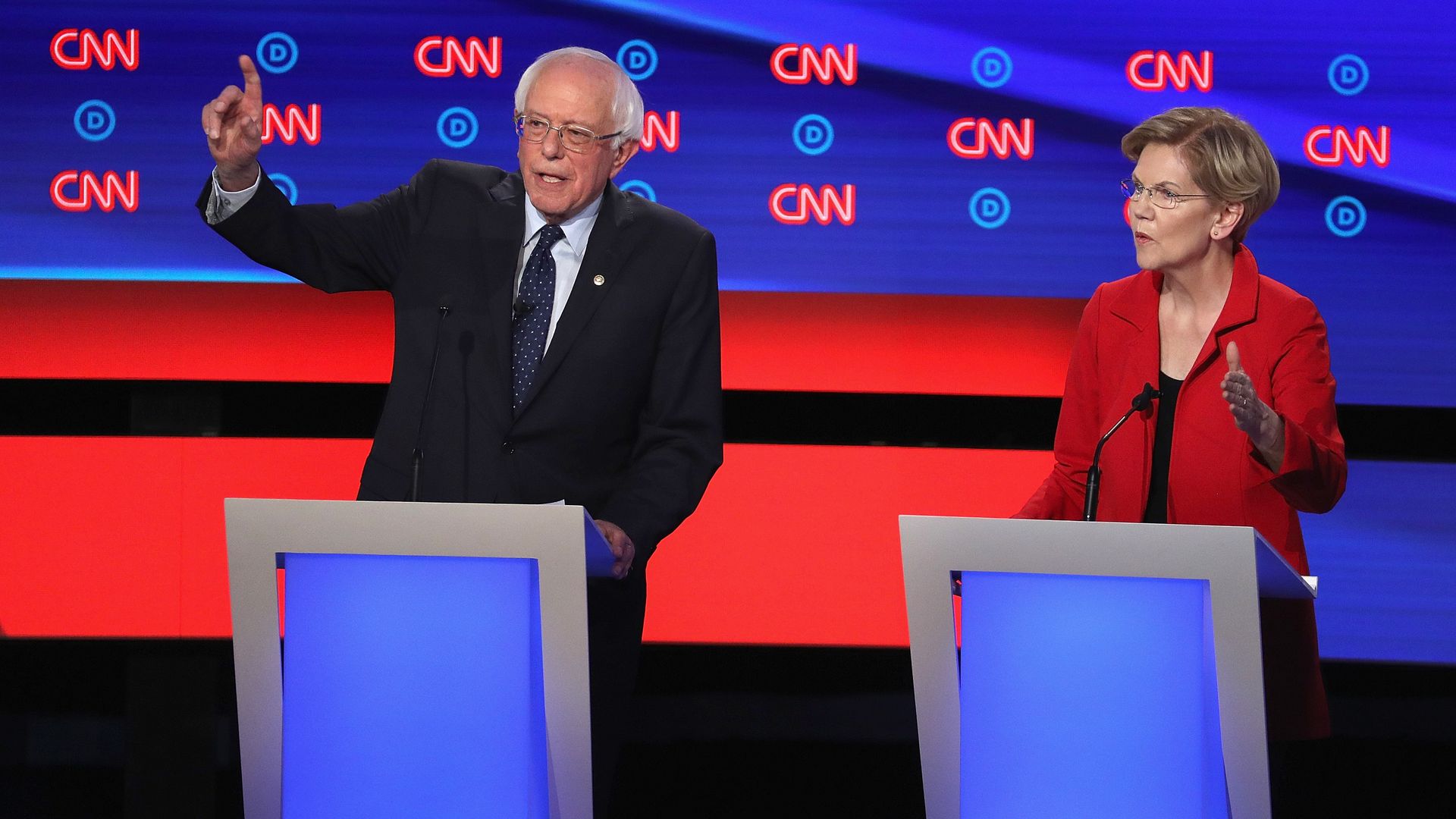 In this image, Warren and Sanders stand next to each other at two podiums on the debate stage.