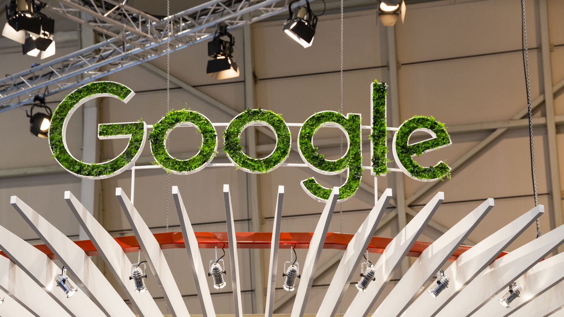 A green Google sign at a conference