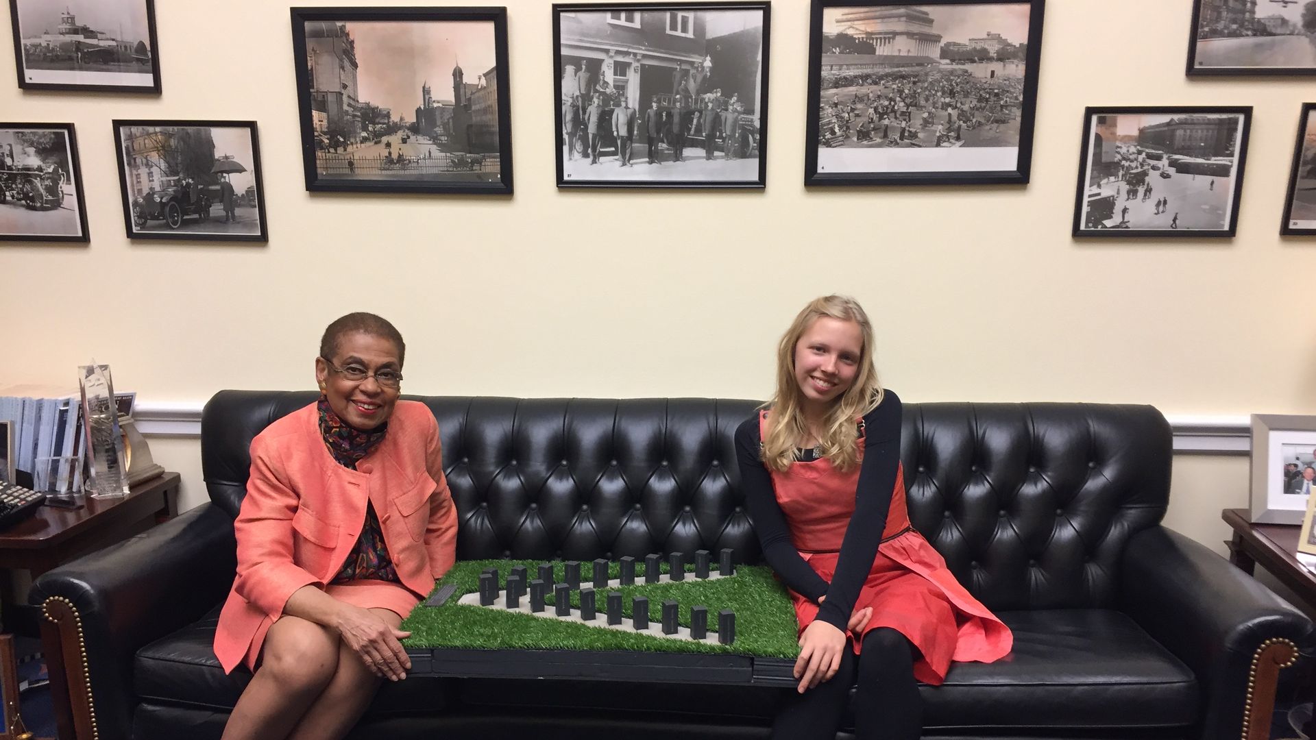 Eleanor Holmes Norton and Raya Kenney with a model of the V shaped memorial