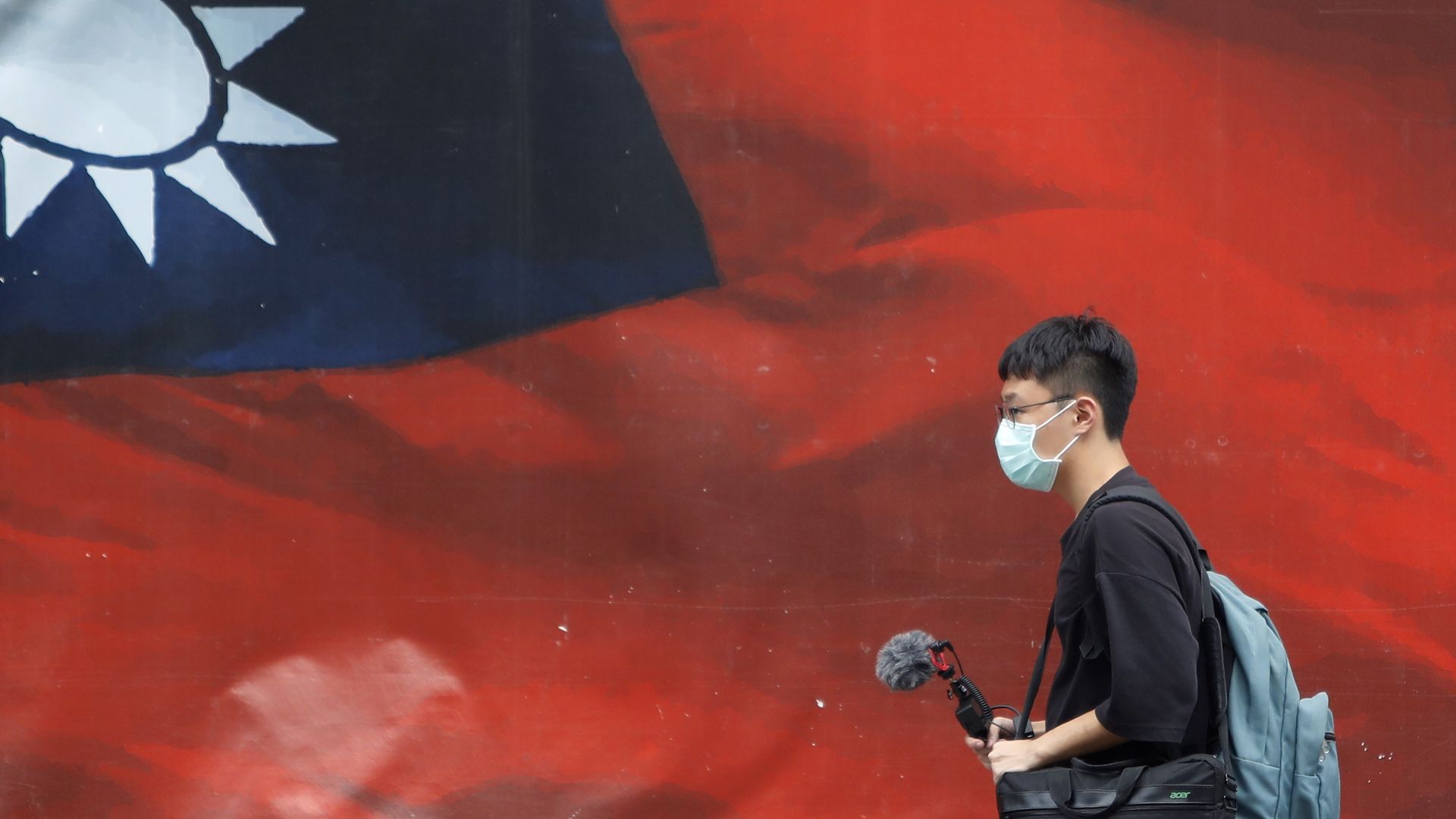 People passing a Taiwan flag in Taipei, Taiwan, on April 11.