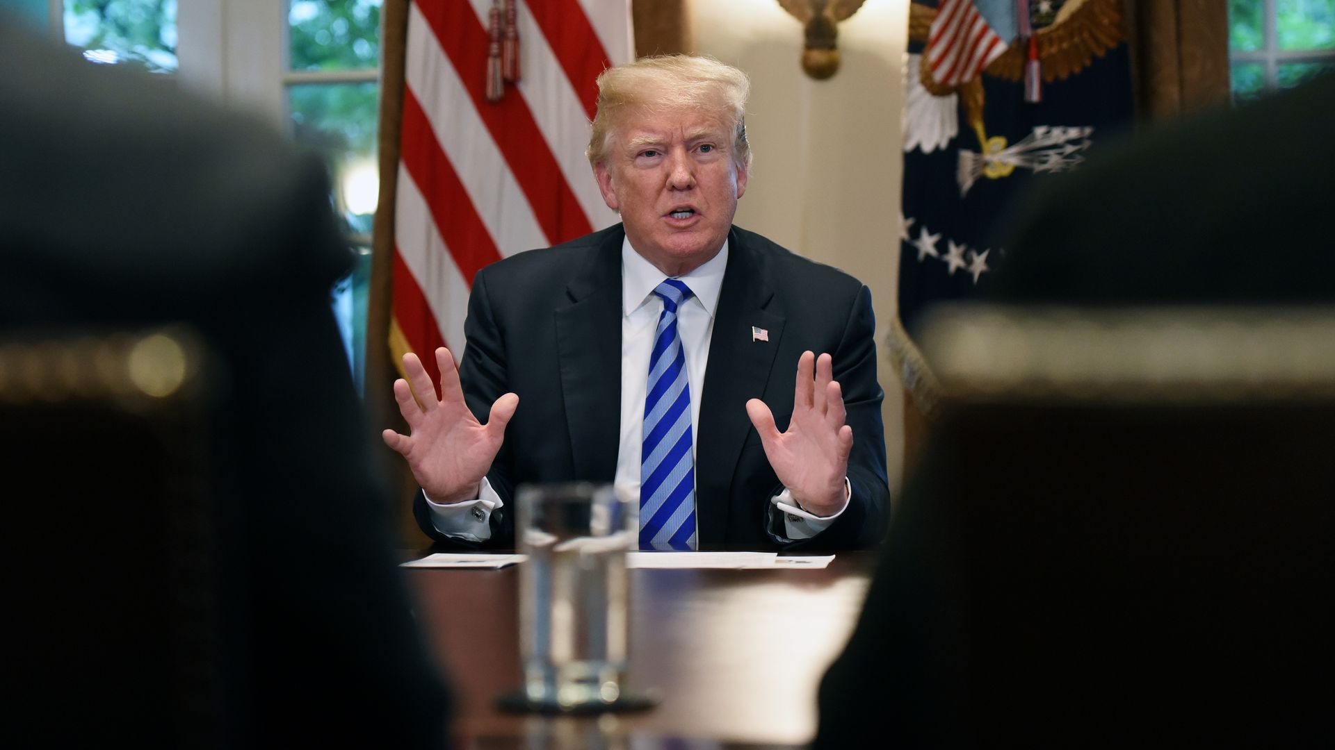 Trump raises his hands while speaking