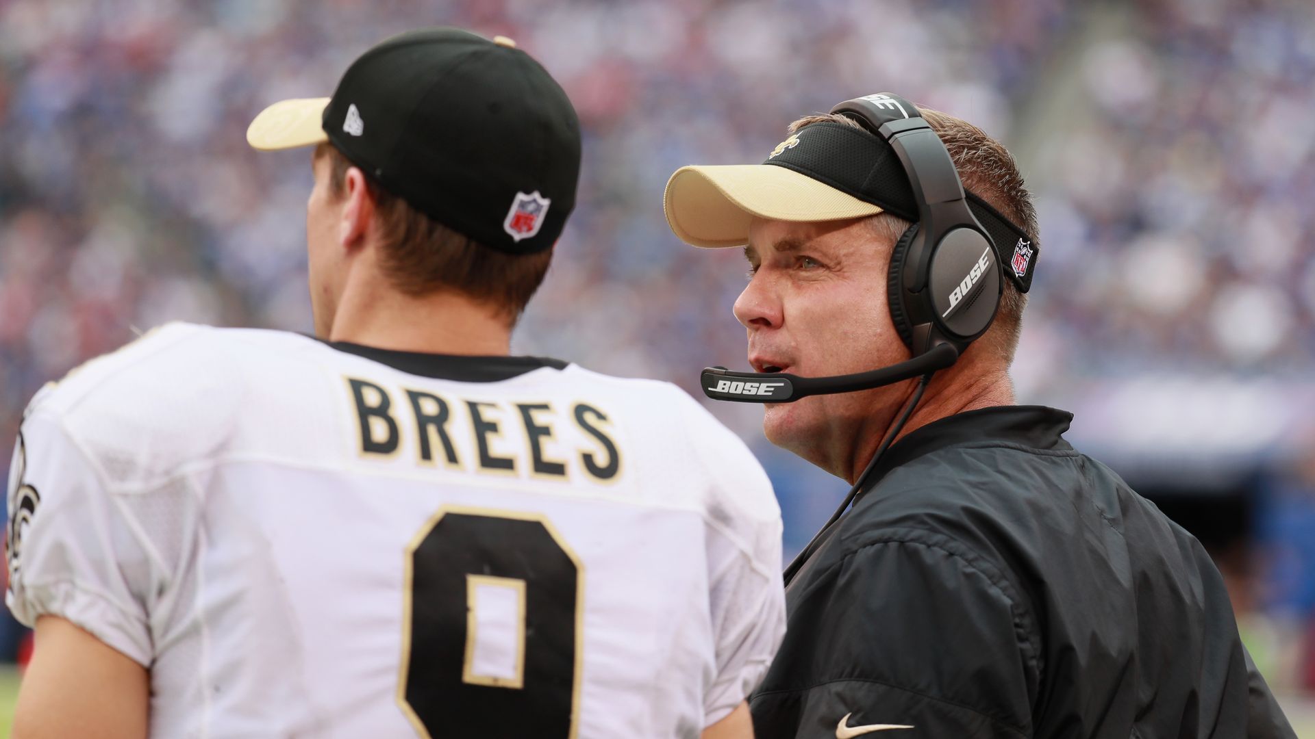 Photo shows Drew Brews in his Saints uniform talking with Sean Payton.
