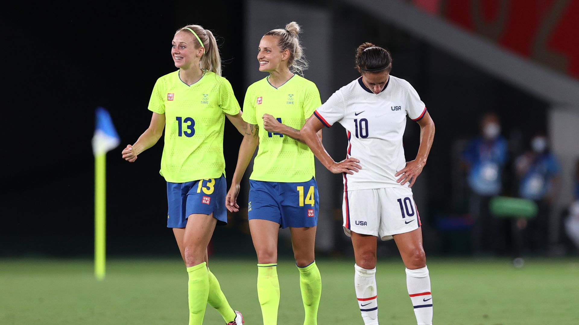 Carli Lloyd and two Swedish players
