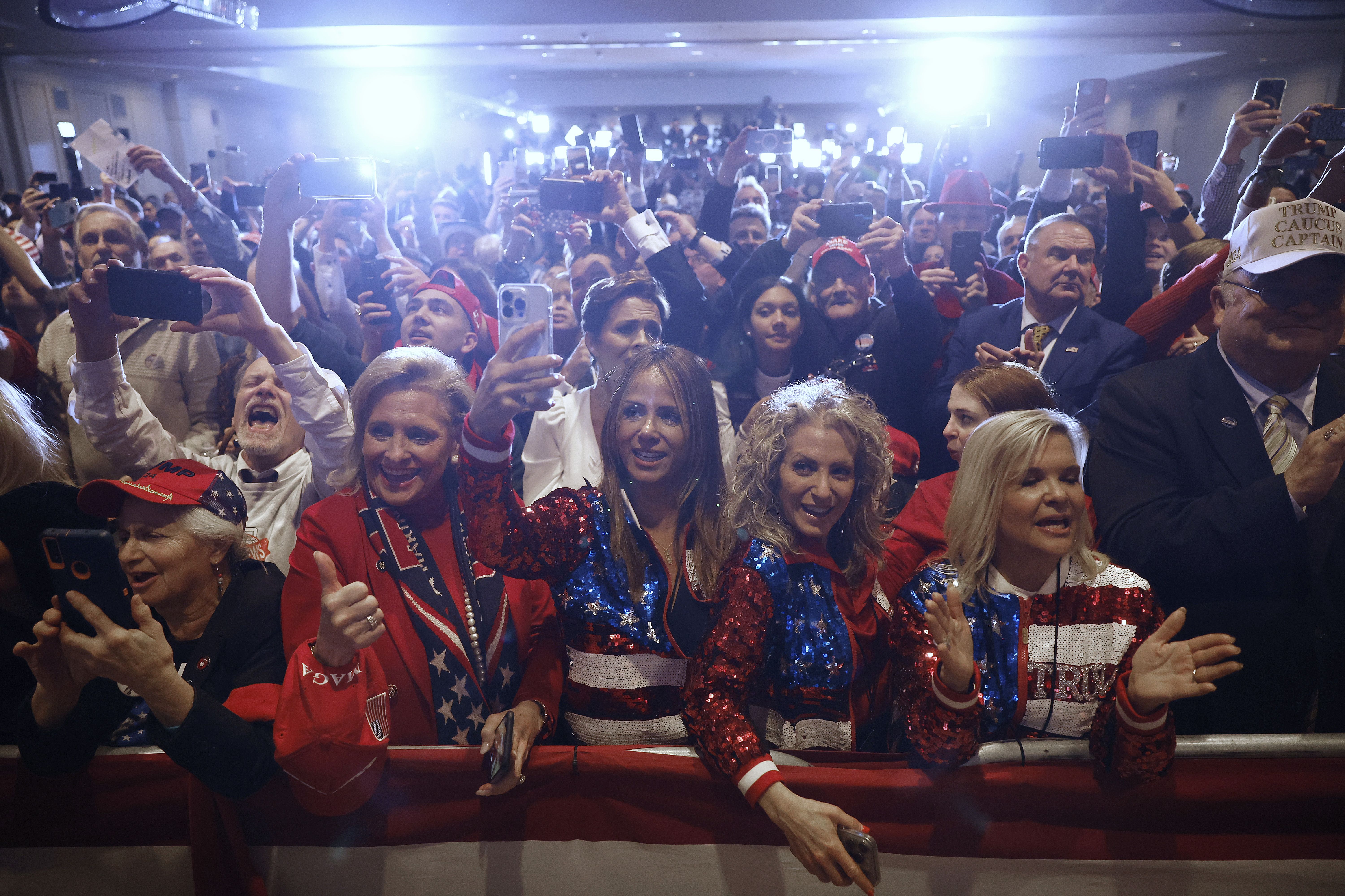 Supporters listen to former President Trump's victory speech last night. 