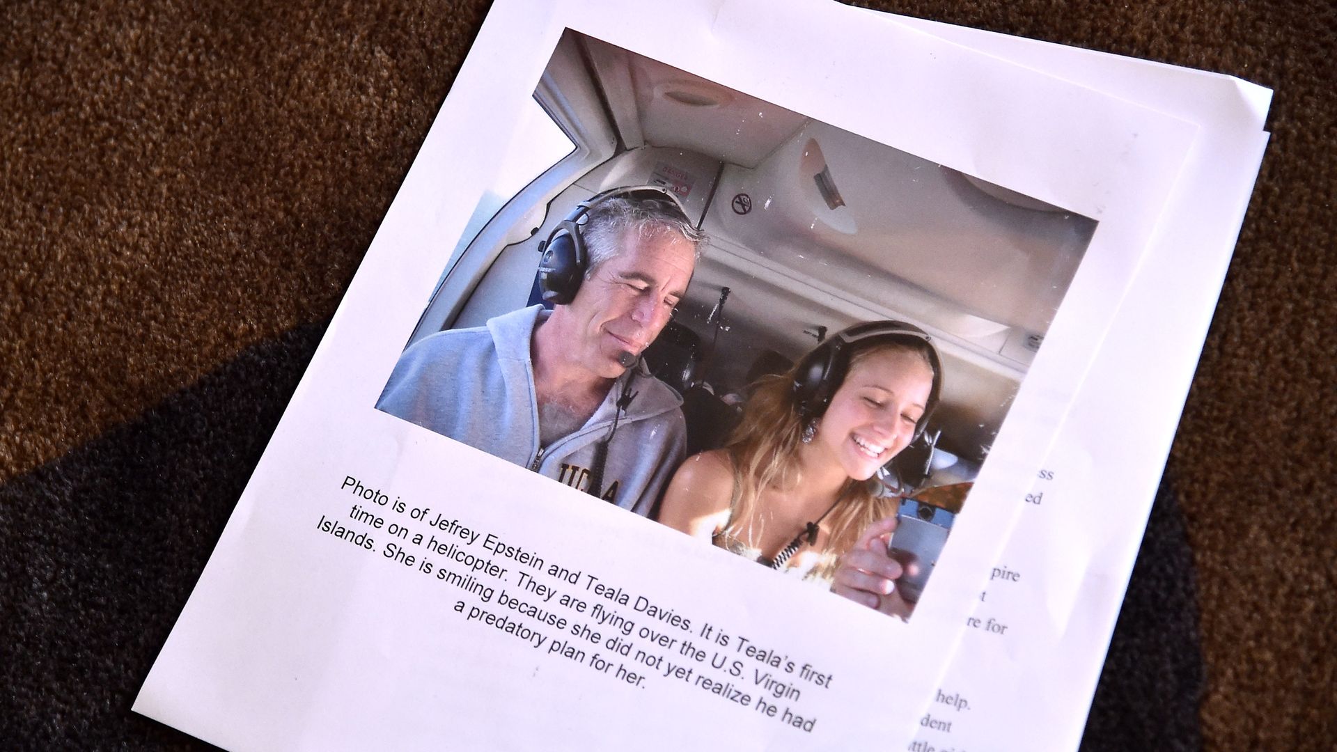 Image of a projected photo showing Jeffrey Epstein and Teala Davies at a 2019 press conference in New York.