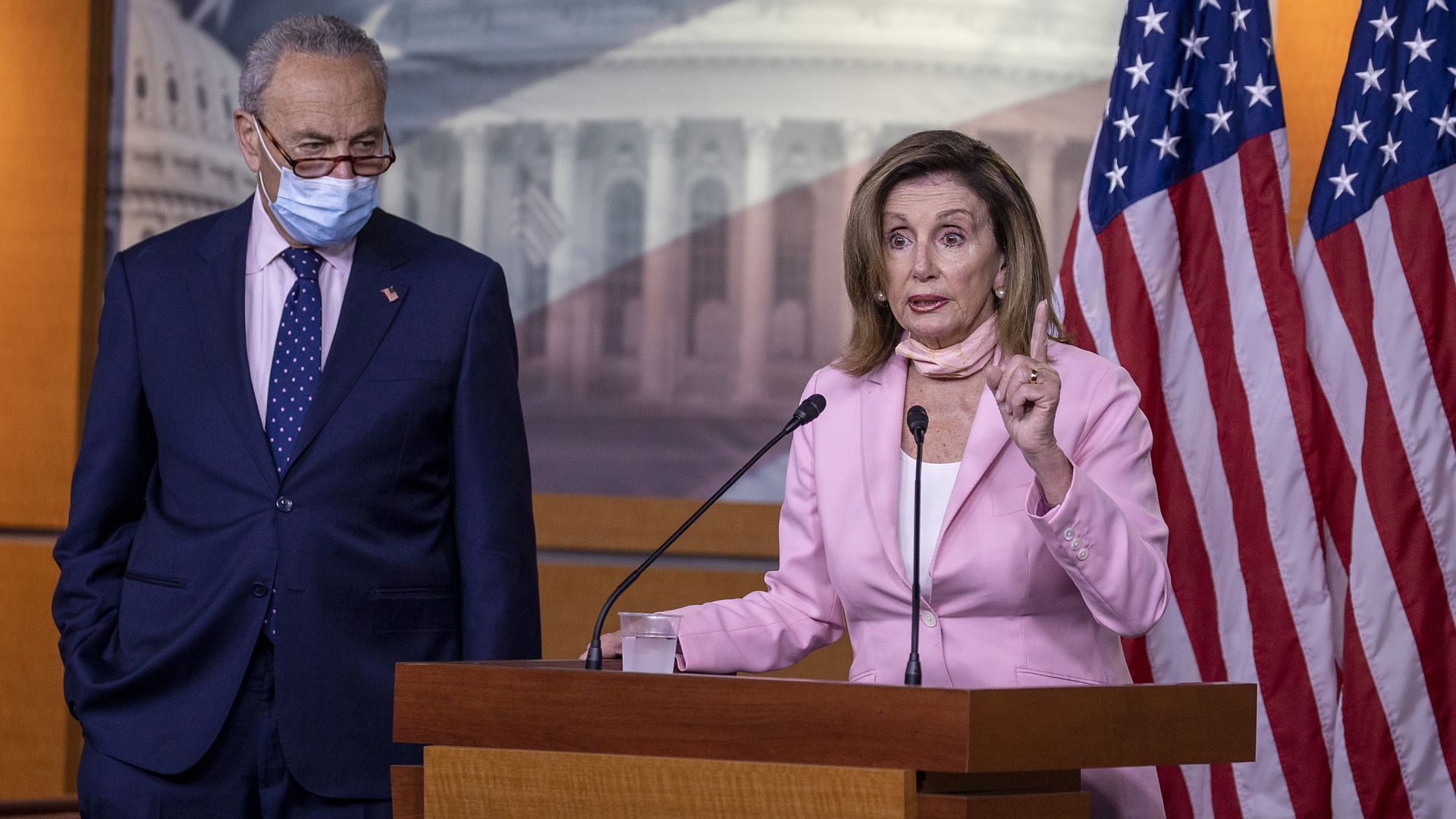 Pelosi and Schumer behind the podium 