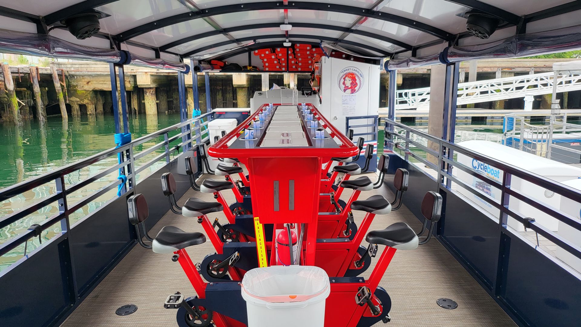 Several bicycle seats and pedals attached to the floor of a small boat.