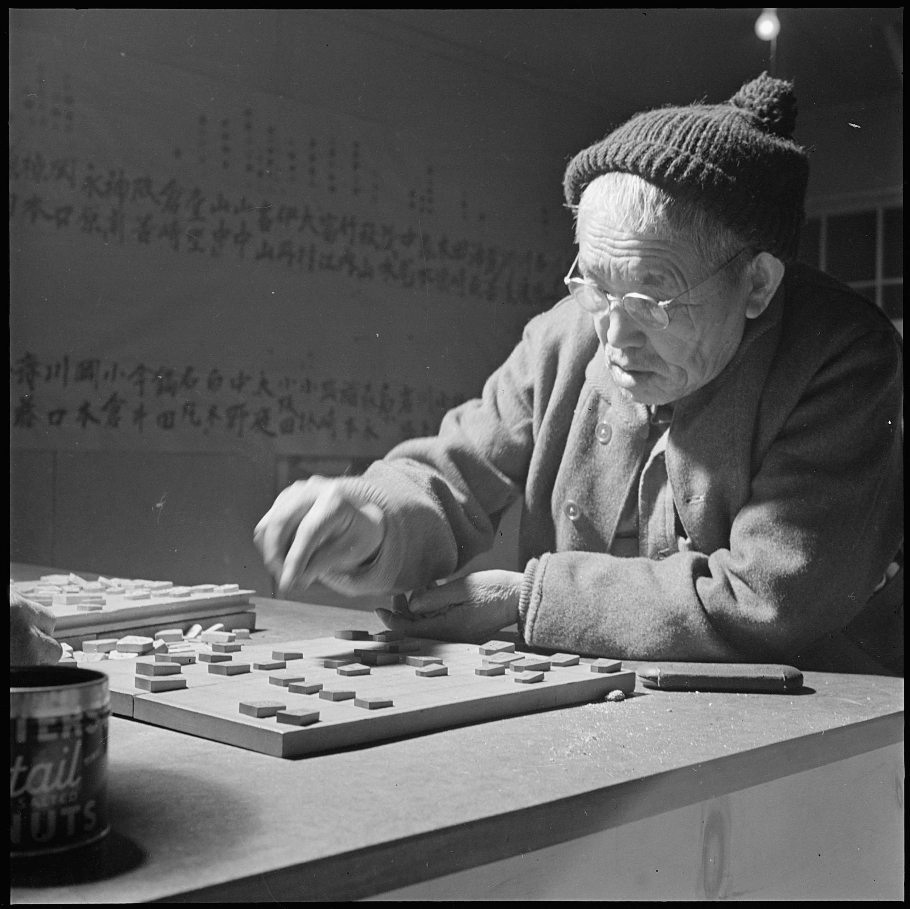 An elderly man playing a game of Shogi.