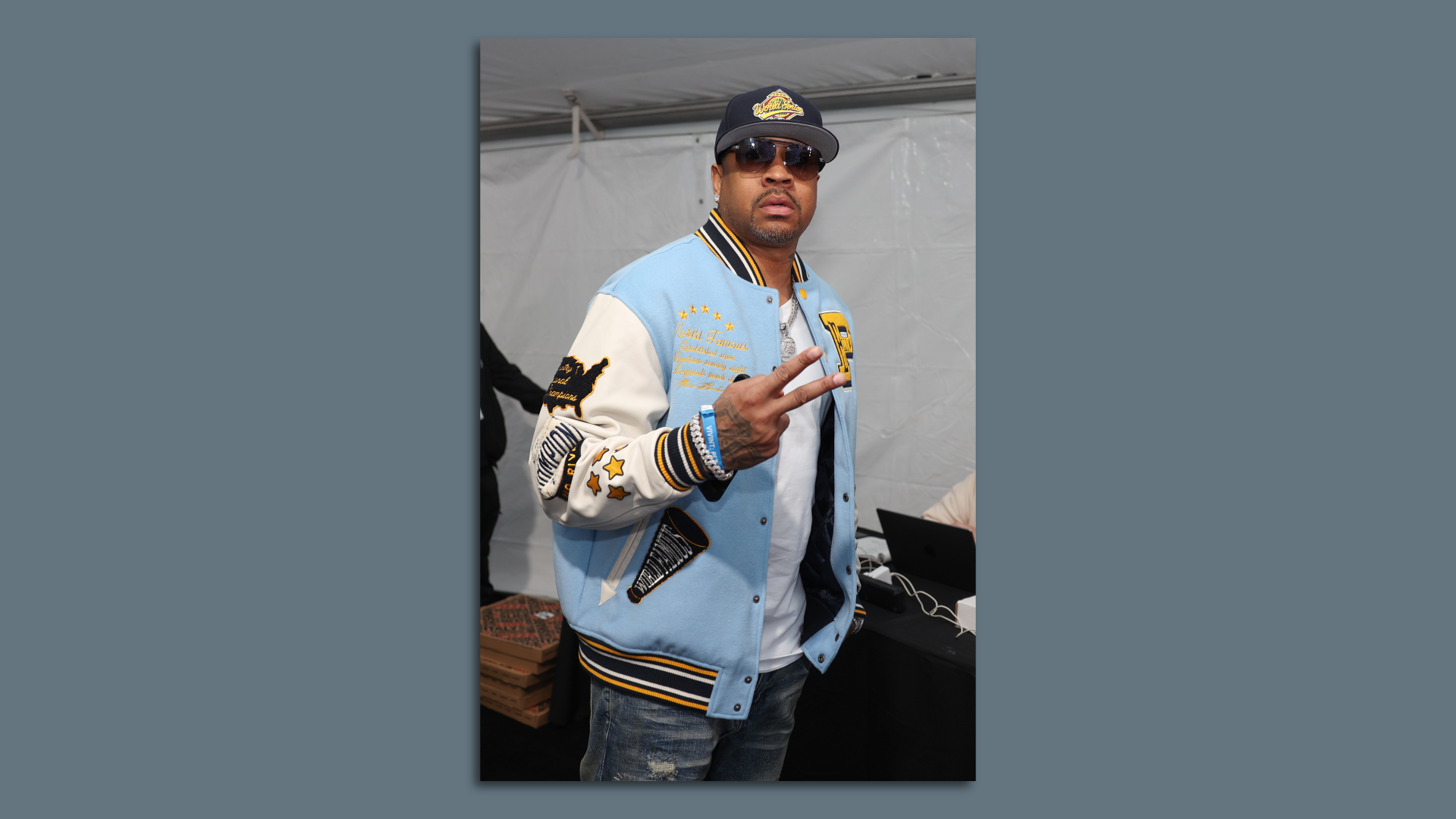 Former 76ers legend Allen Iverson throws up the peace sign.