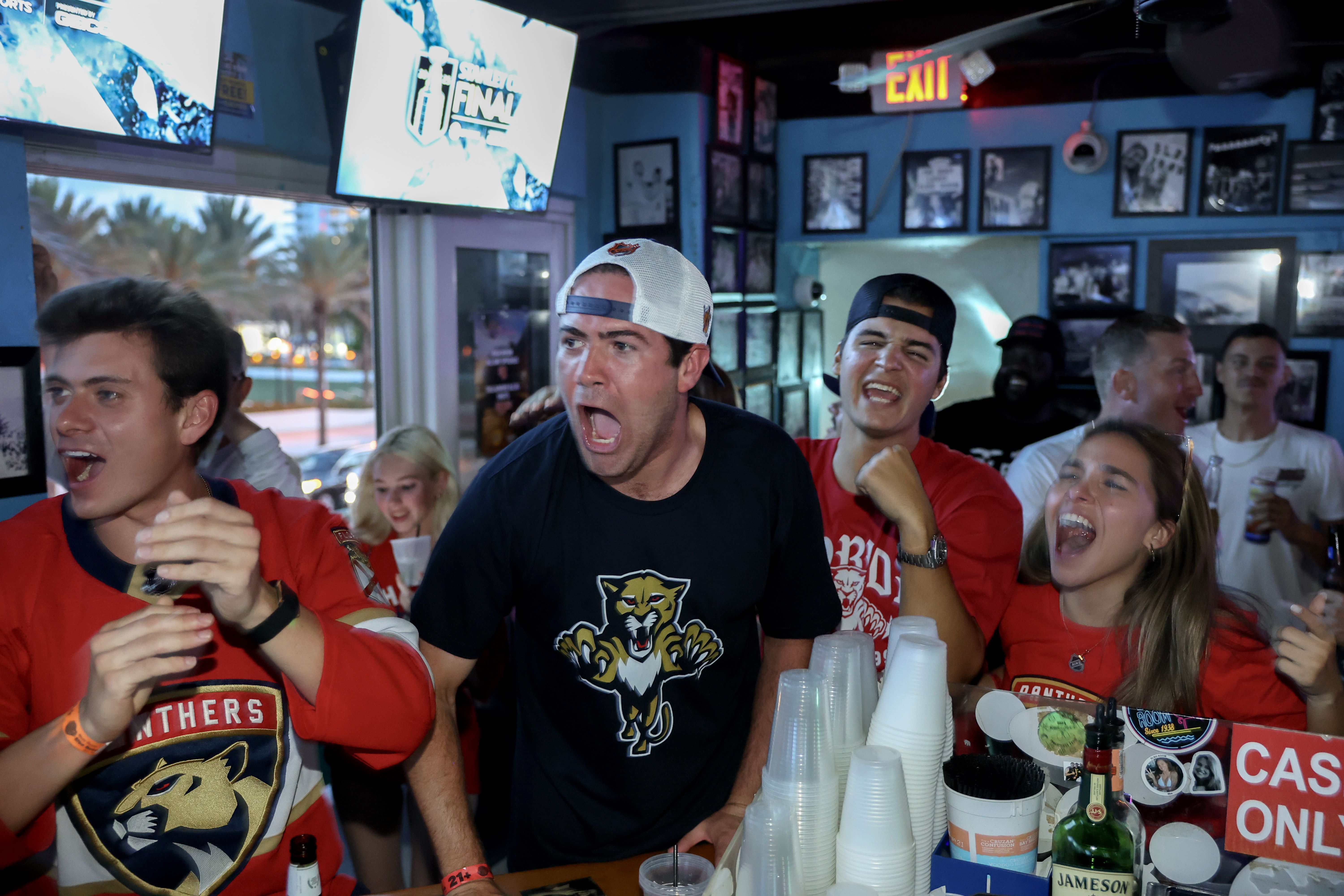FORT LAUDERDALE, FLORIDA - JUNE 17: Kyle Gomez (2nd L) and other Florida Panthers fans react as they watch on television the Florida Panthers and Edmonton Oilers play in Game Six of the 2025 Stanley Cup Final at the Elbo Room on June 17, 2025 in Fort Lauderdale, Florida. The Panthers would become th