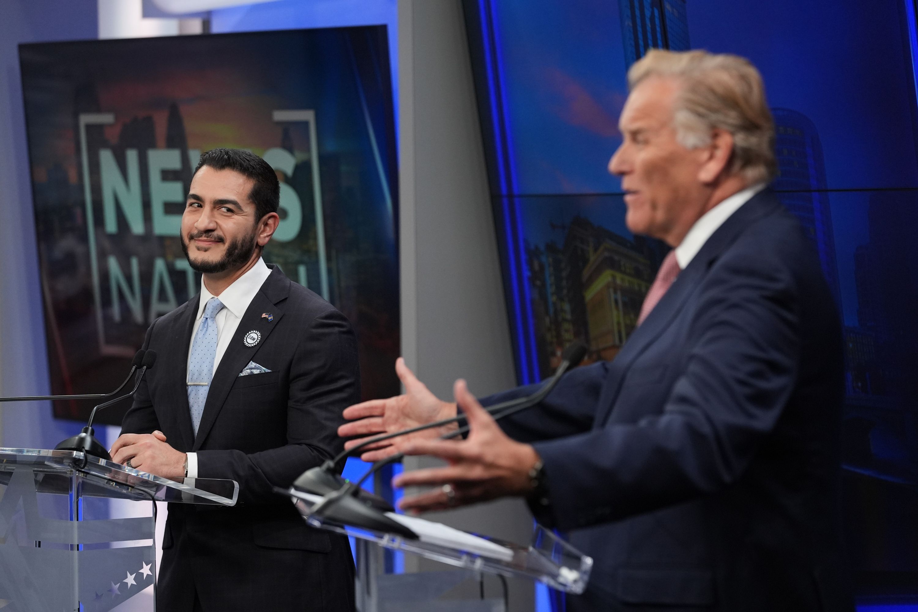 El-Sayed and Rogers on stage behind podiums