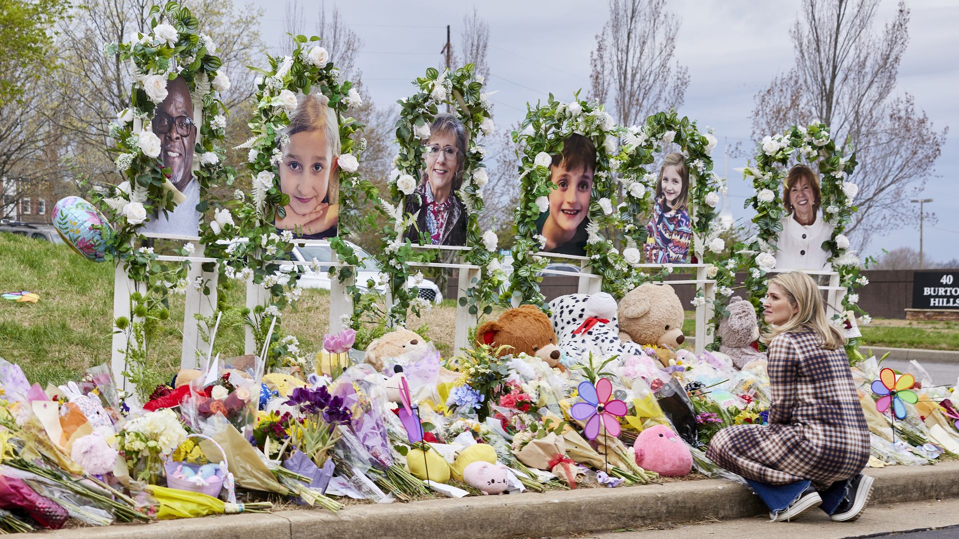 NASHVILLE, TN - MARCH 31 - A woman looks on at the memorial for the Covenant School shooting victims at the Covenant School.