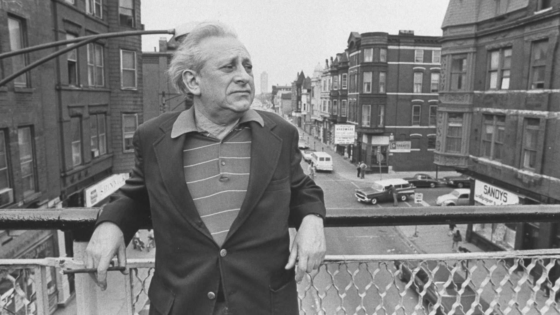 Guy standing on elevated train platform 