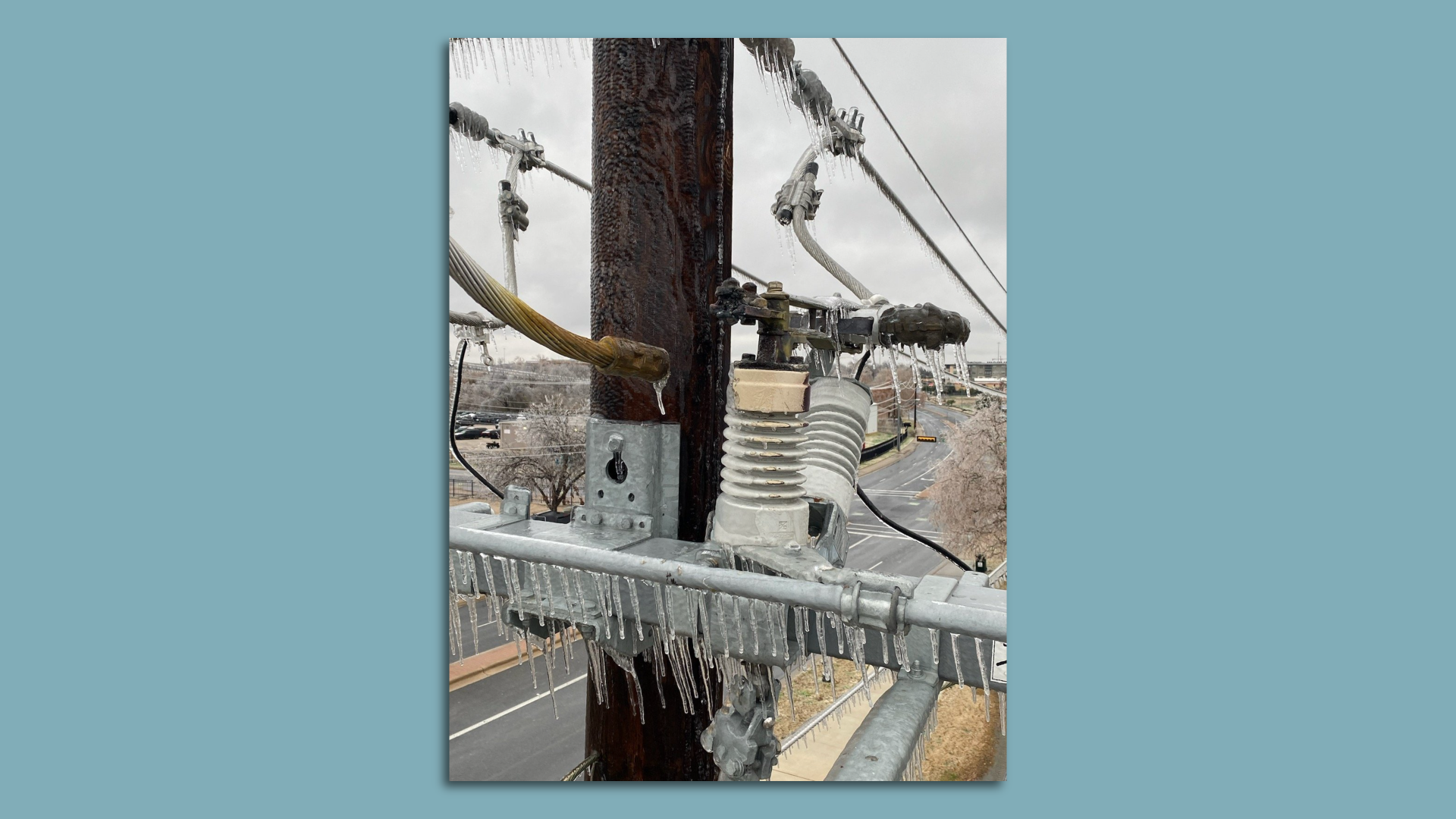 A photo of a frozen power line.