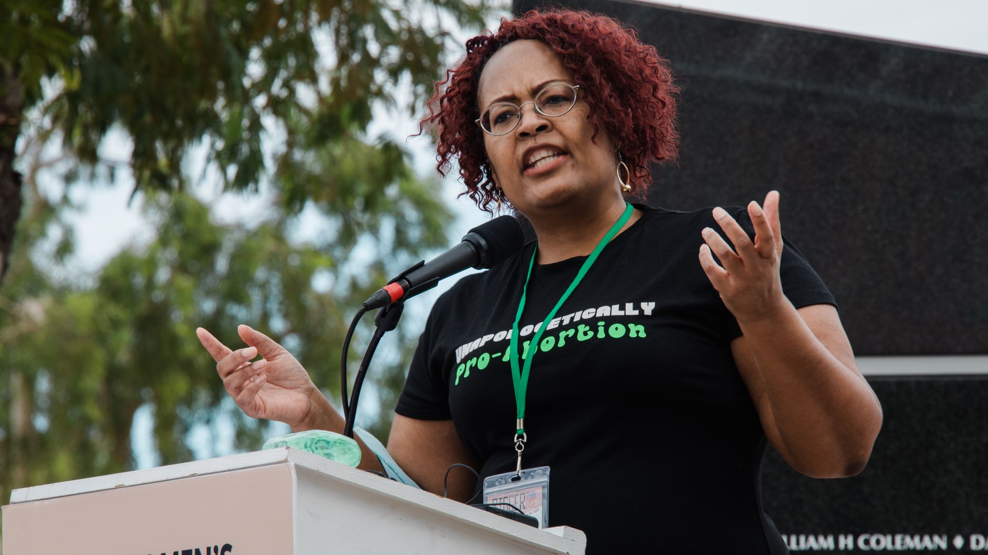 A woman speaking at a podium.