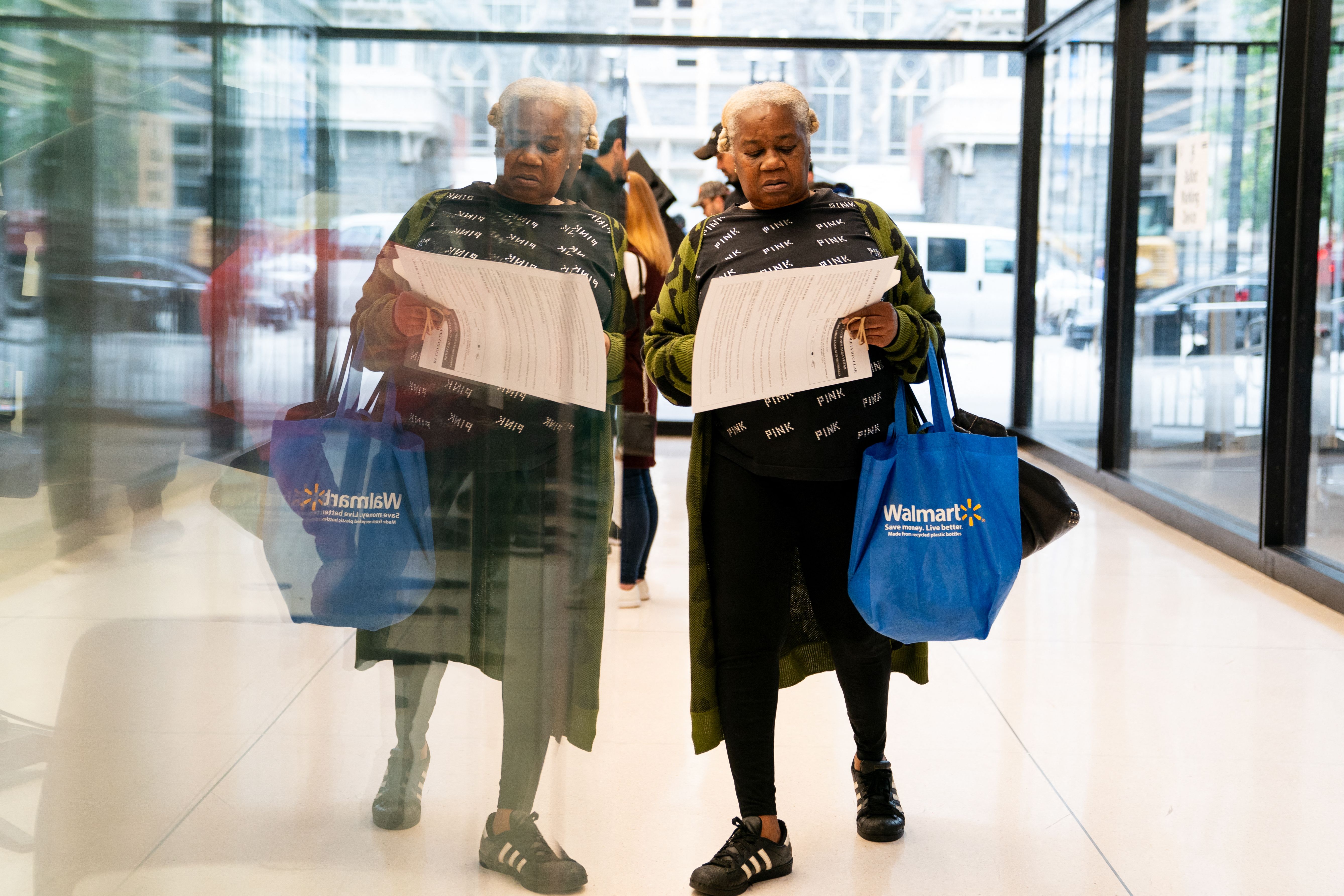 A woman carries her ballot. 