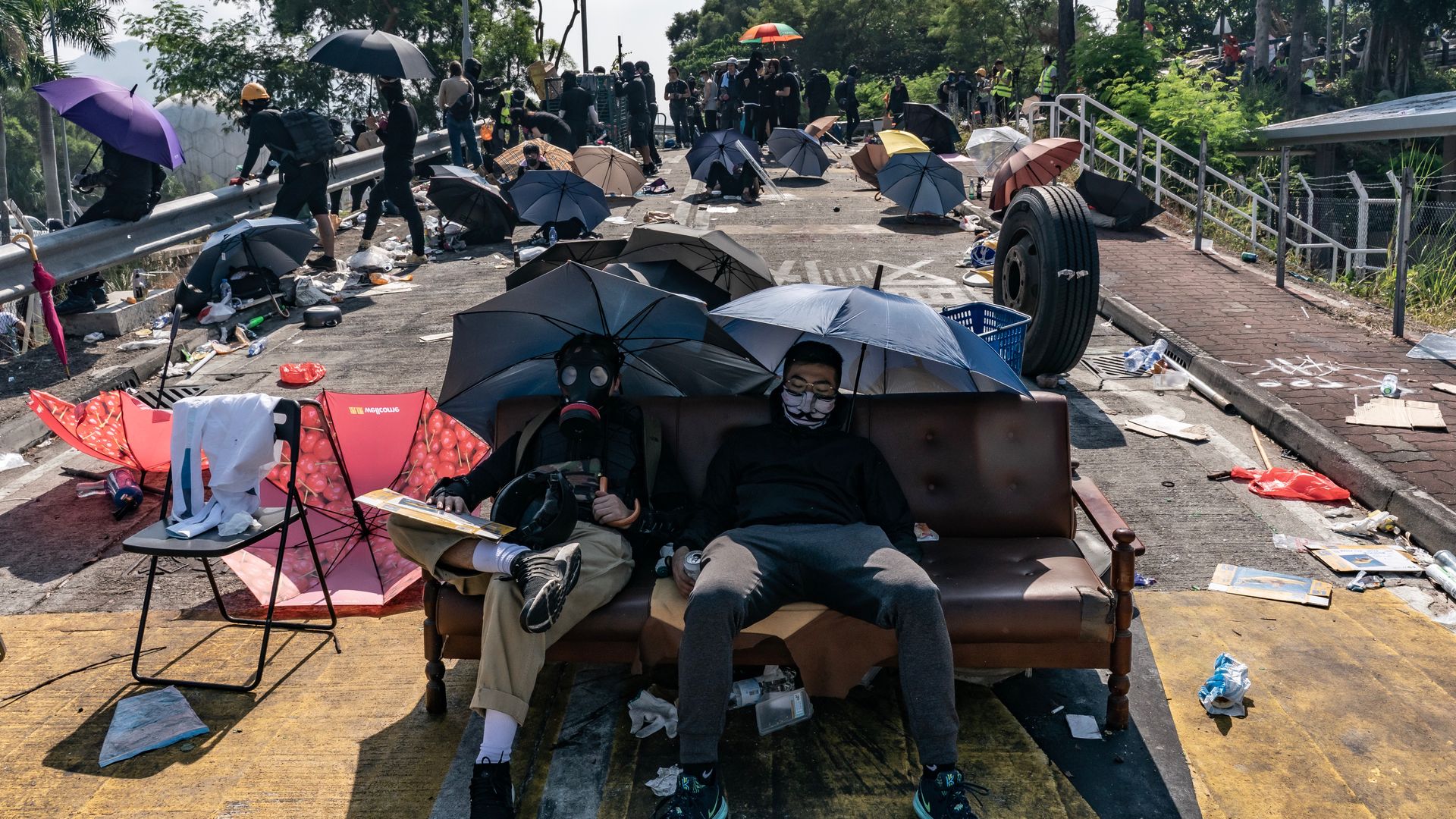 Pro-democracy protesters rest on a couch on the No.2 bridge at Chinese University of Hong Kong on November 13, 2019 in Hong Kong