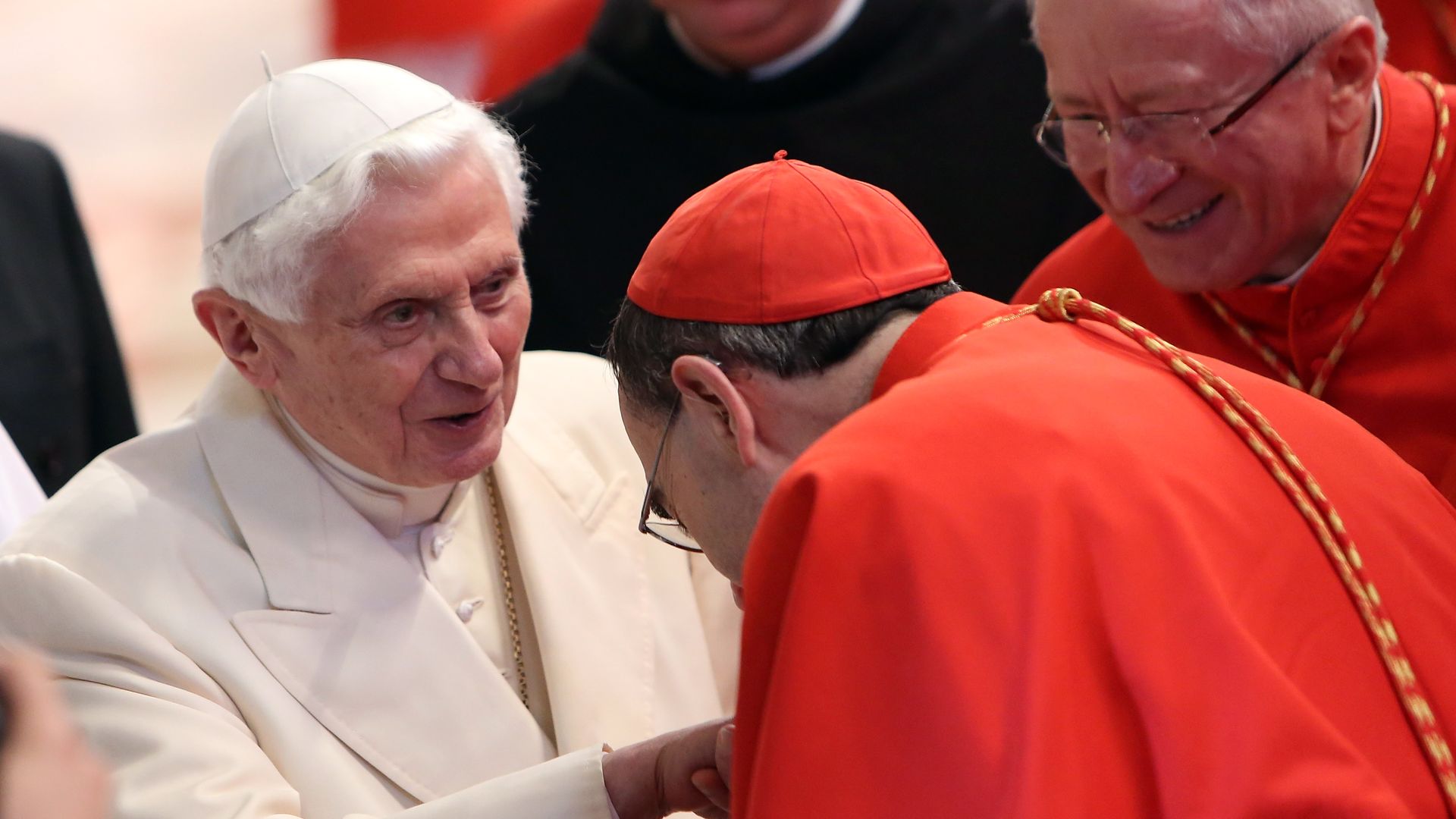 Pope Benedict XVI greeting cardinals at St. Peter's Basilica in 2014 in Vatican City, Vatican.