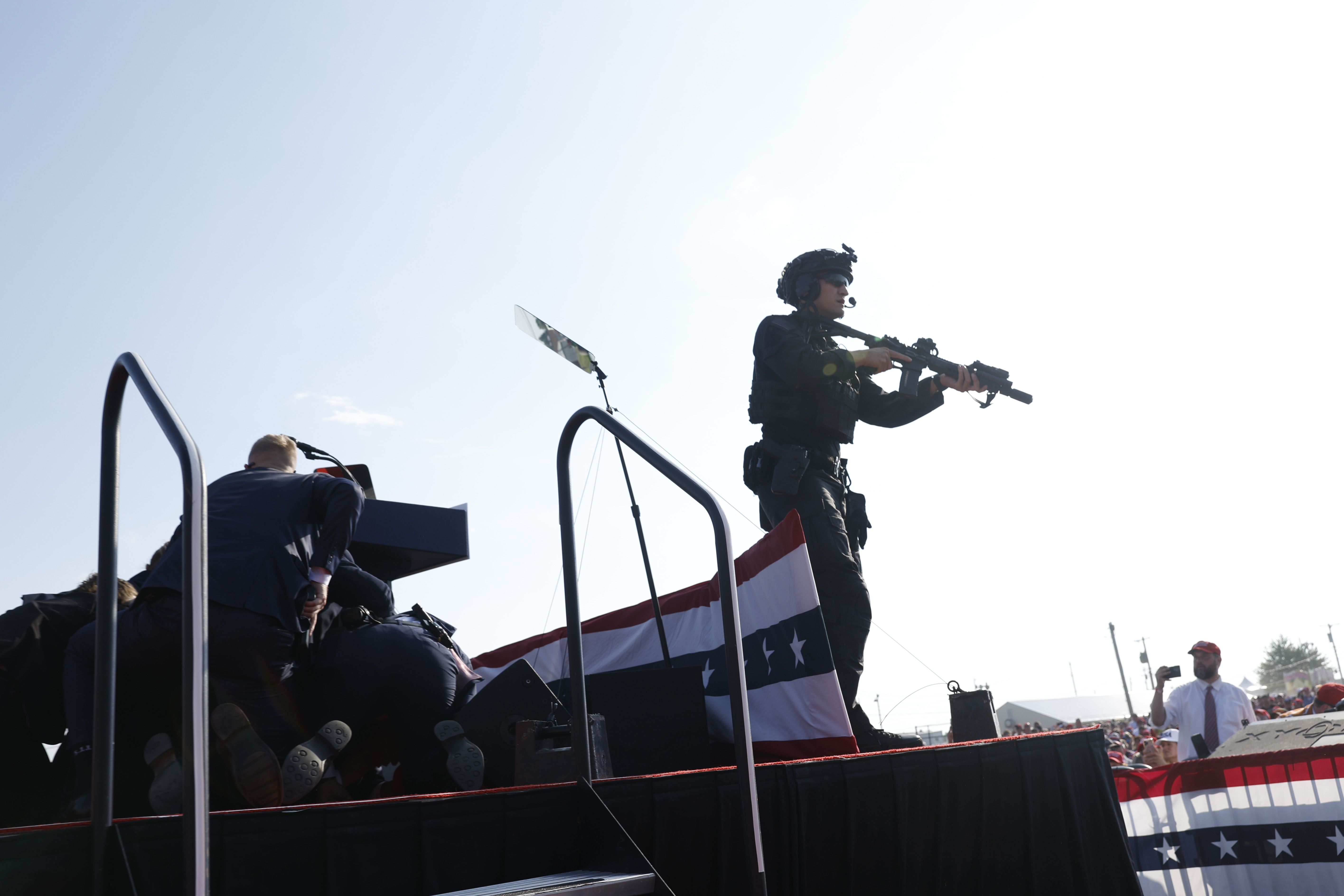 Former president Trump is escorted off stage after shots ring out. 