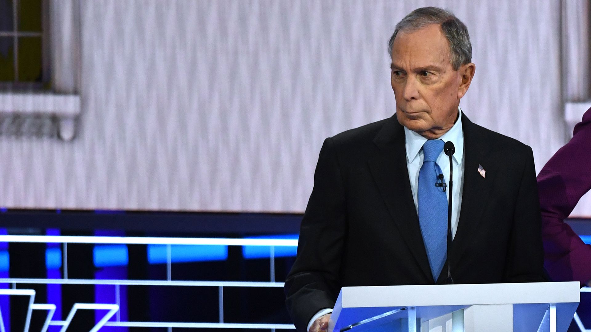 In this image, Michael Bloomberg stands on the debate stage