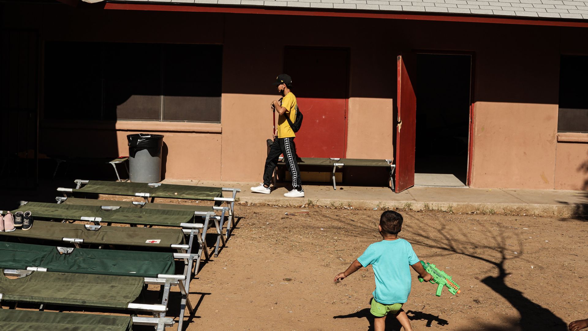A migrant child plays in a courtyard at the Holding Institute shelter in Laredo, Texas, U.S., on Saturday, May 15