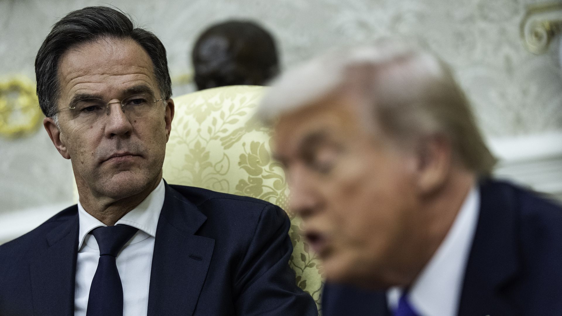 Two men in suits, Mark Rutte and Donald Trump, sit in the Oval Office in the White House.