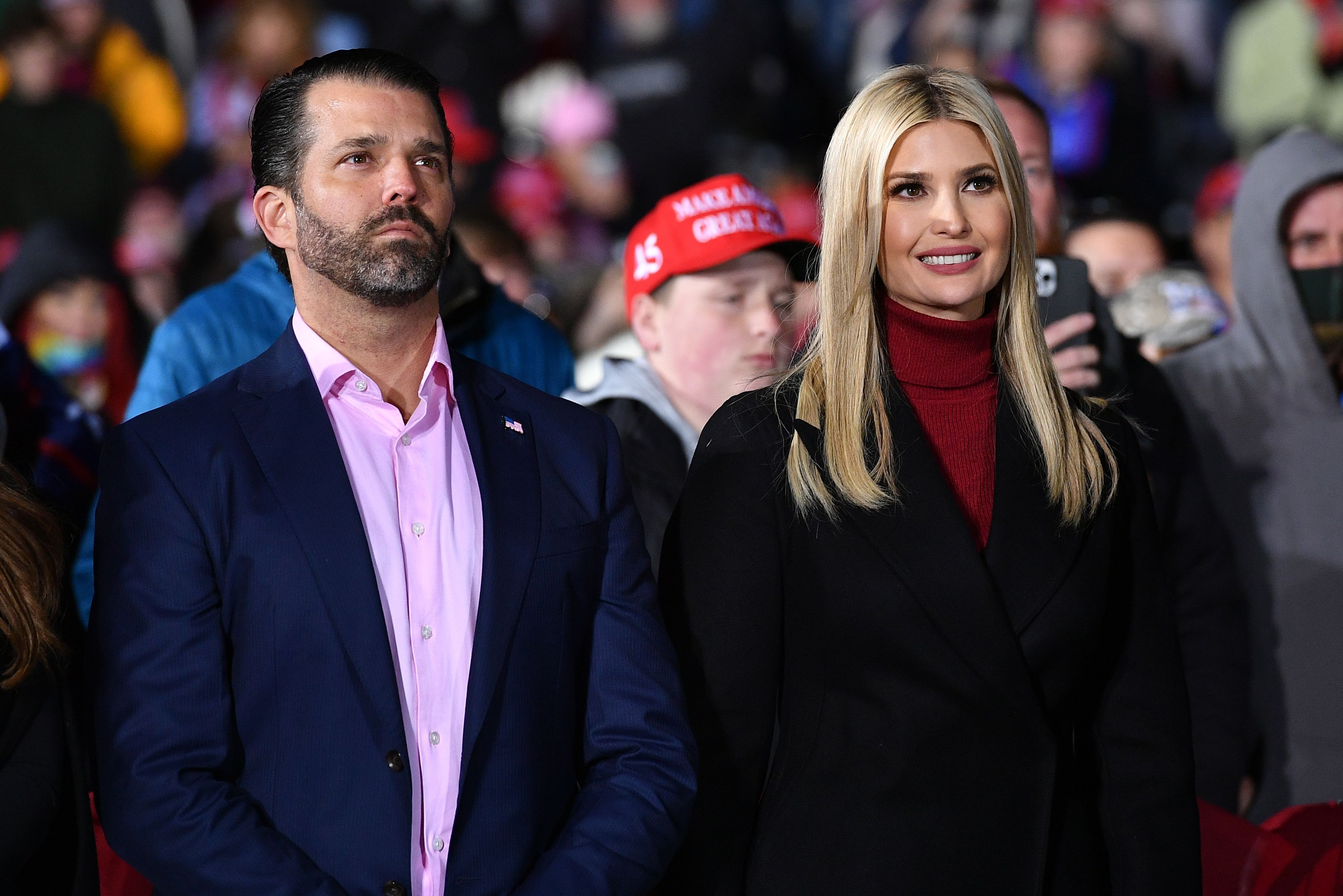 Senior advisor to the President Ivanka Trump (R) and brother Donald Trump Jr. listens during a rally in Georgia