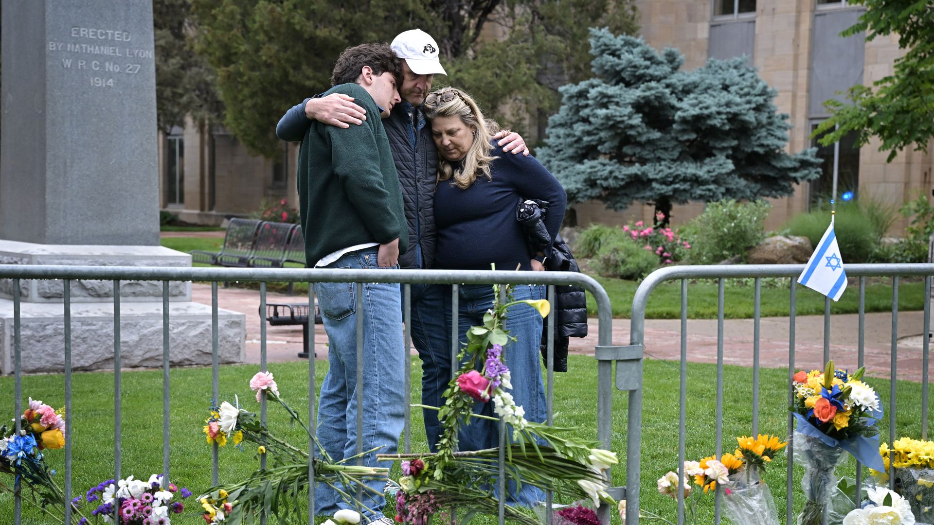 From left, Isaac Dechtman of Denver comforts each other with his parents Evan and Jennifer at the Boulder county courthouse on Pearl Street in Boulder on Tuesday.