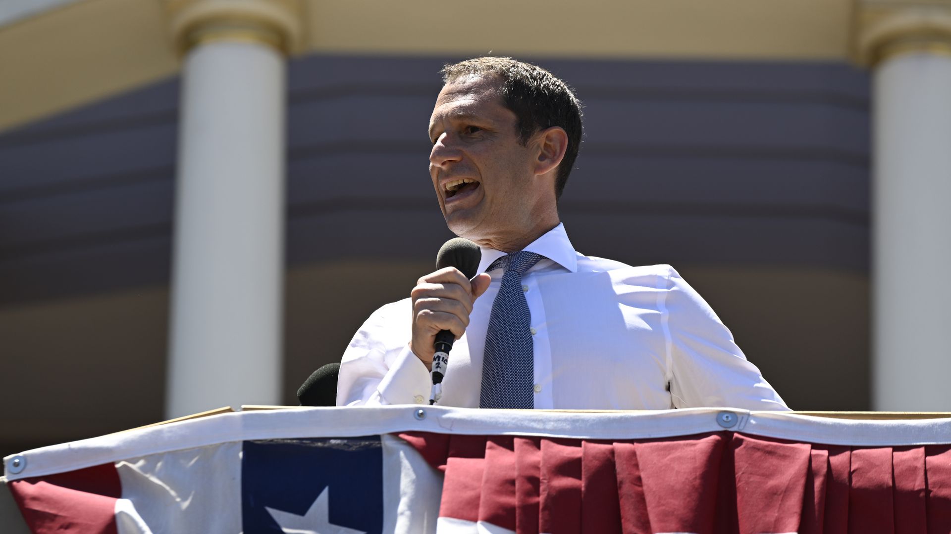 Inside a restaurant decorated with a large colorful dragon hanging from the ceiling, yellow fairy lights, red lanterns, and wooden tables with chairs set for dining.