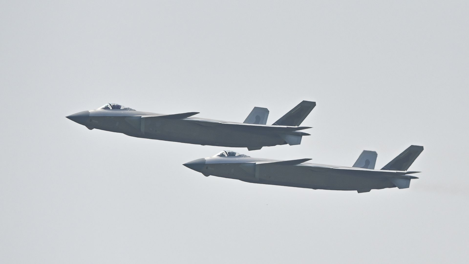 Two J-20 stealth fighter jets perform in the sky during the 13th China International Aviation and Aerospace Exhibition on September 29, 2021 in Zhuhai, Guangdong Province of China