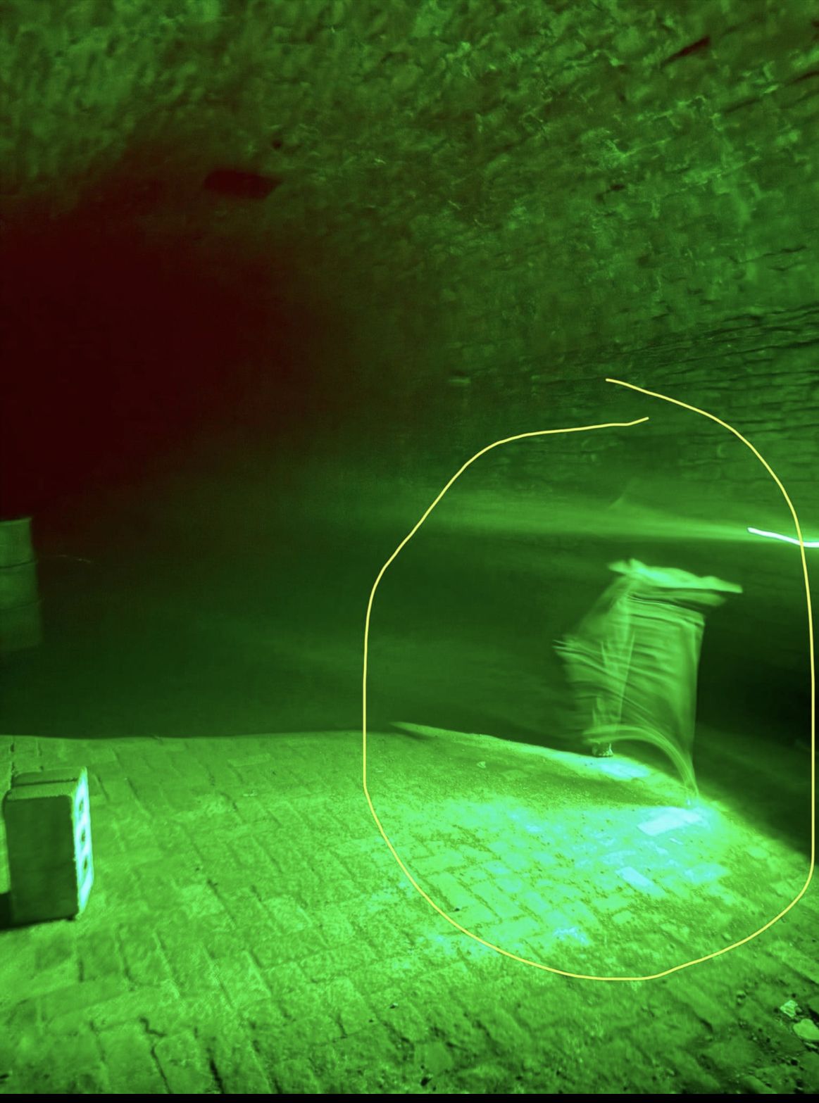 A photo taken during a tour using a green flashlight appears to show a mysterious figure — complete with what look like bare toes — in the historic tunnels. Tour operators say no guests were barefoot or transparent. Proof? You decide. Photo: Courtesy of Miranda McGee