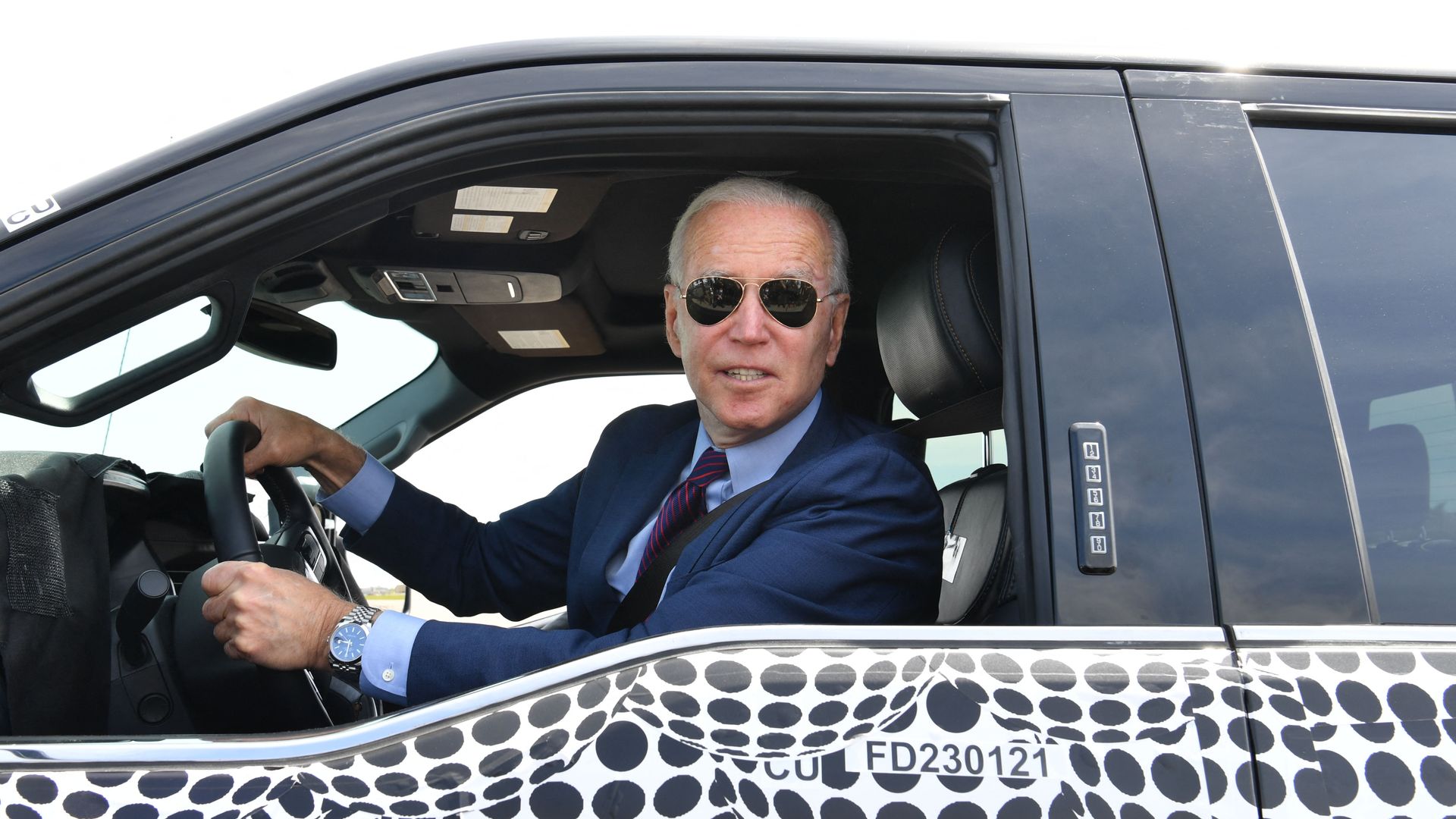 President Biden is seen driving an electric F-150 pickup truck during a visit to a Ford plant in Michigan.