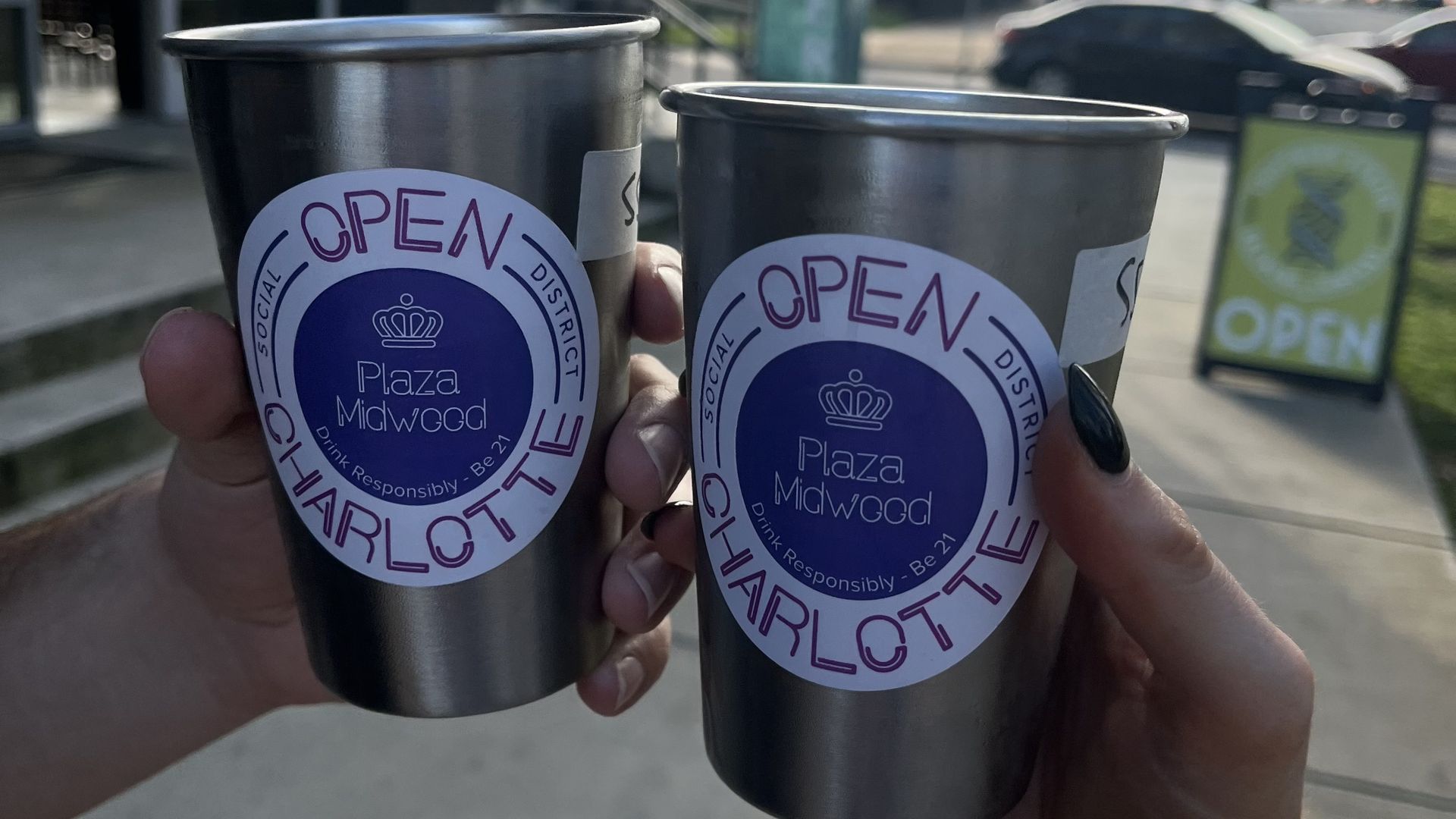 Two metal cups with social district stickers