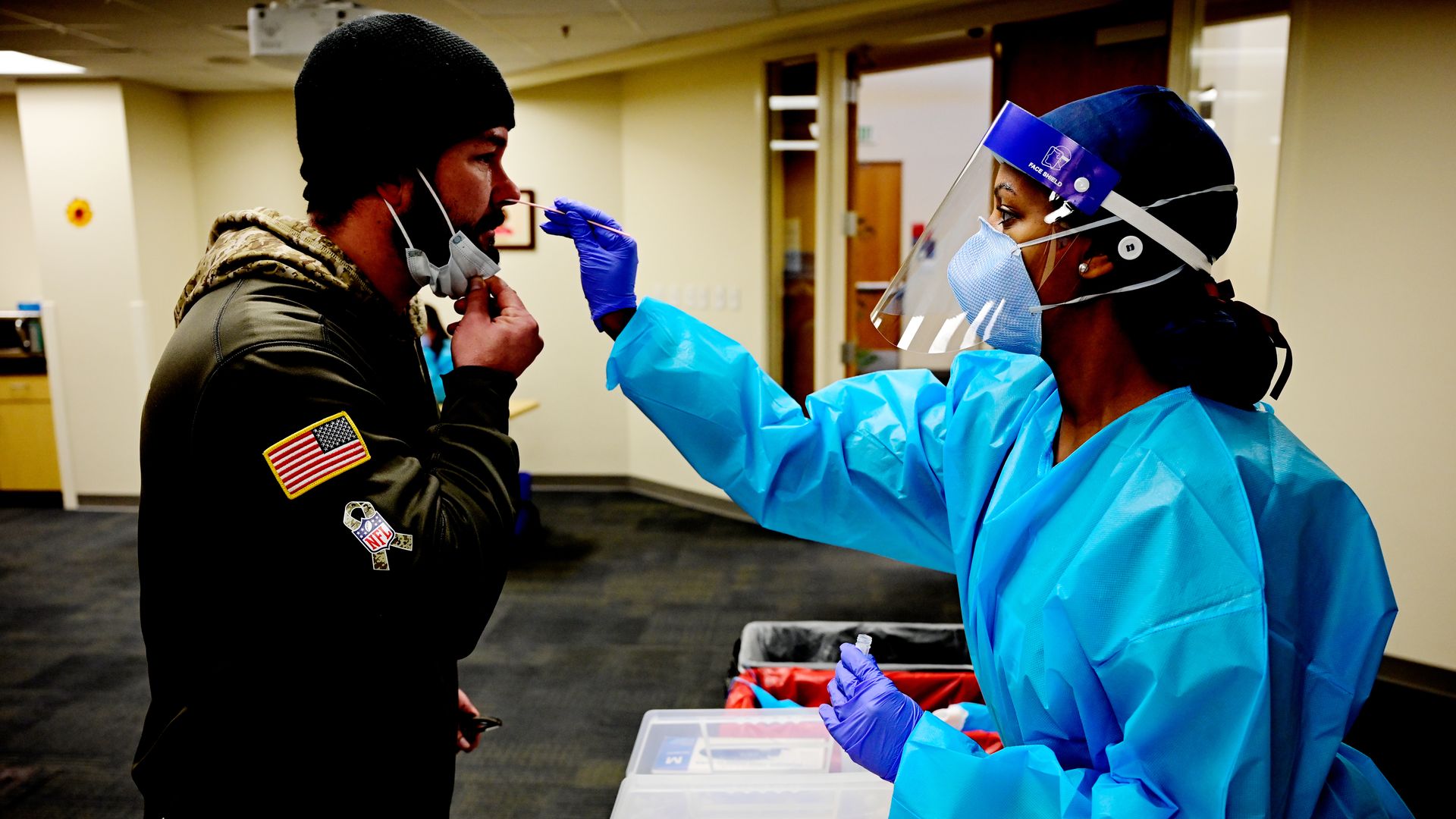A nurse administers a PCR COVID test.