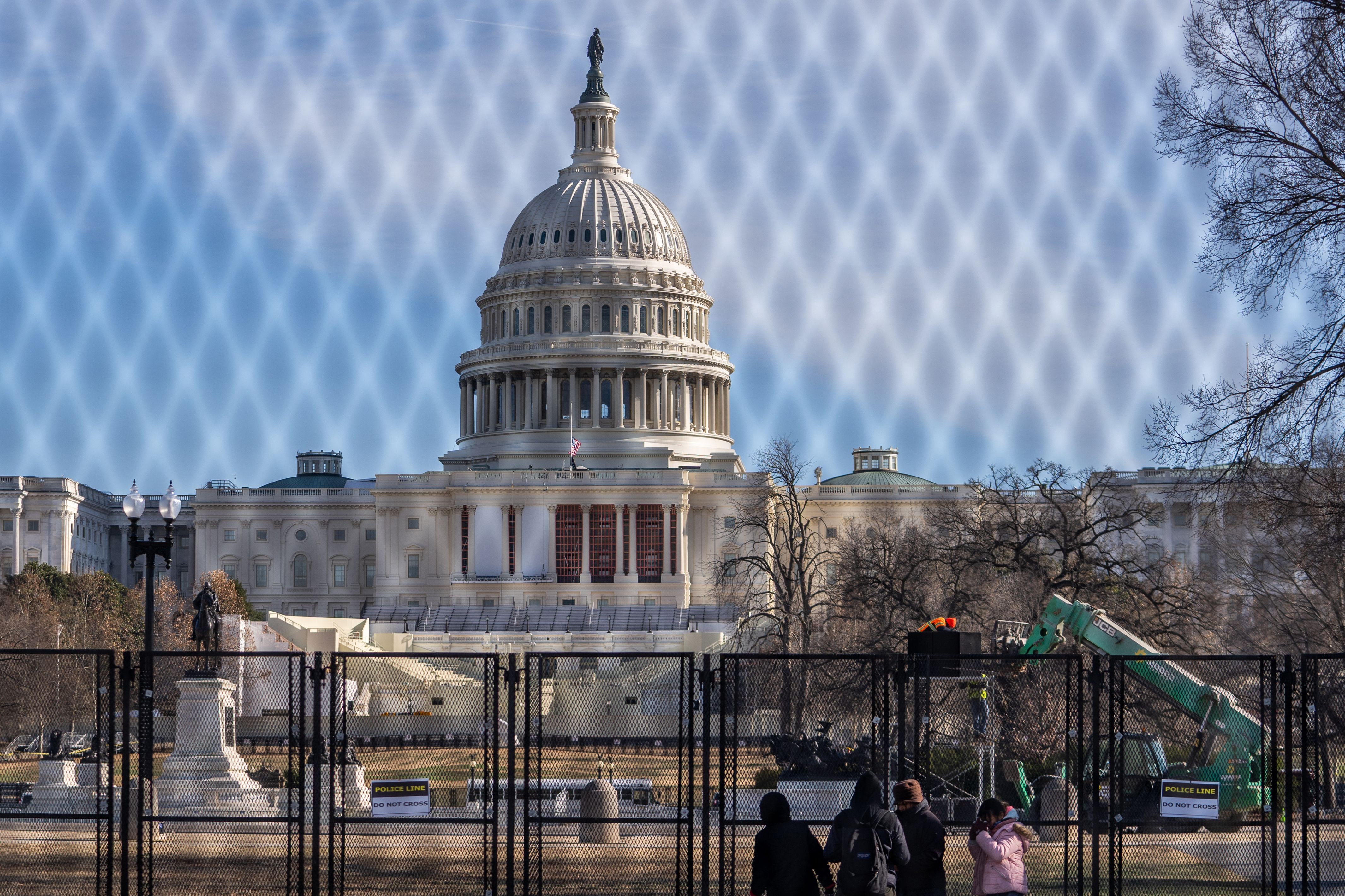 The US Capitol building is seen through security fencing on the National Mall ahead of the January 6th certification of the 2024 Presidential Election in Congress in Washington, DC, on January 5, 2025. (Photo by Allison ROBBERT / AFP) (Photo by ALLISON ROBBERT/AFP via Getty Images)