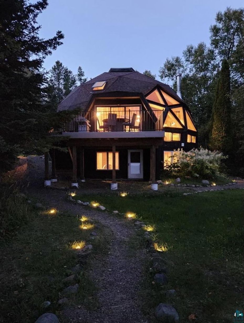 A photo of a dome home at night.