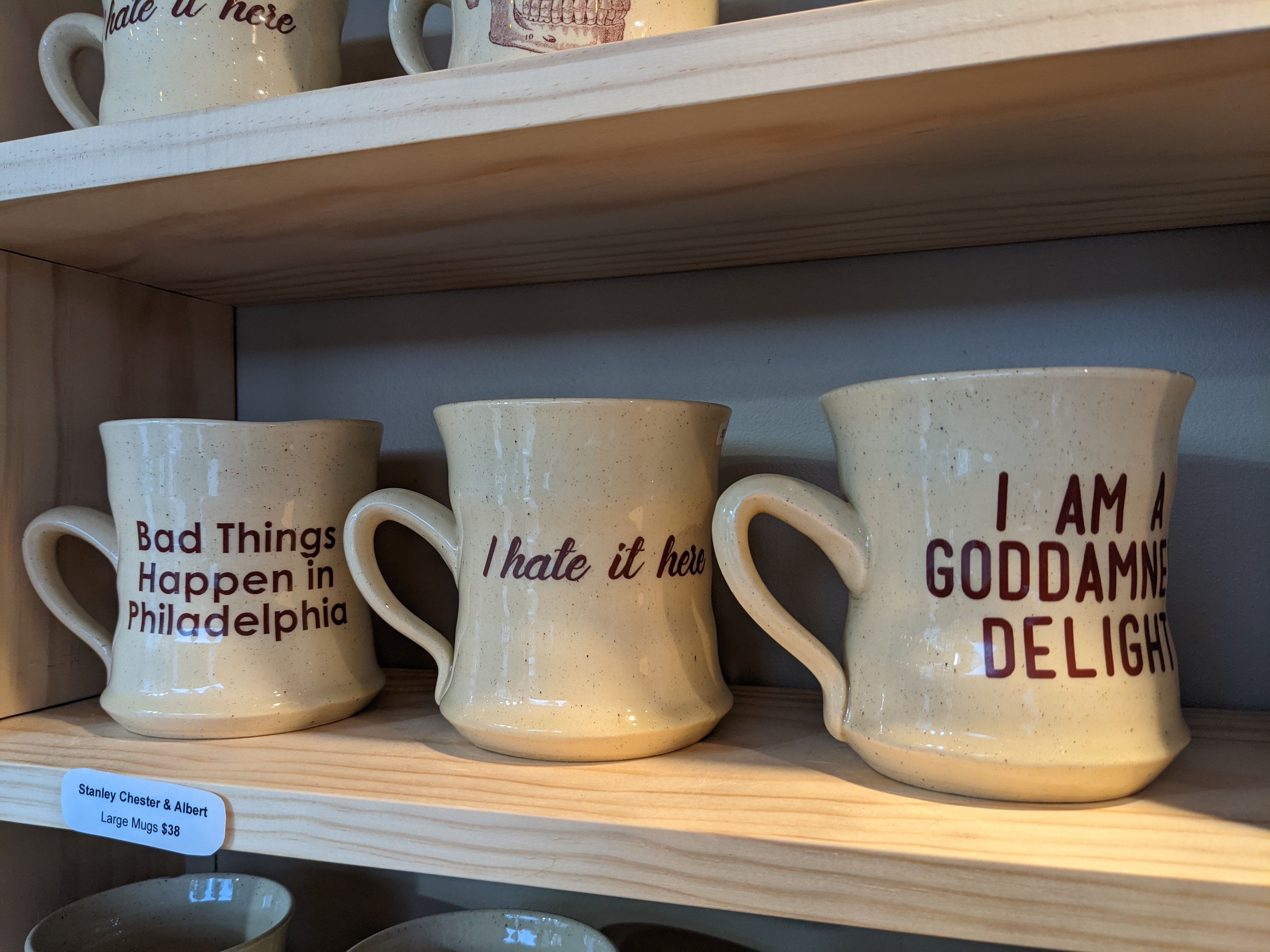 A collection of mugs, with one saying, "Bad Things Happen in Philadelphia." 