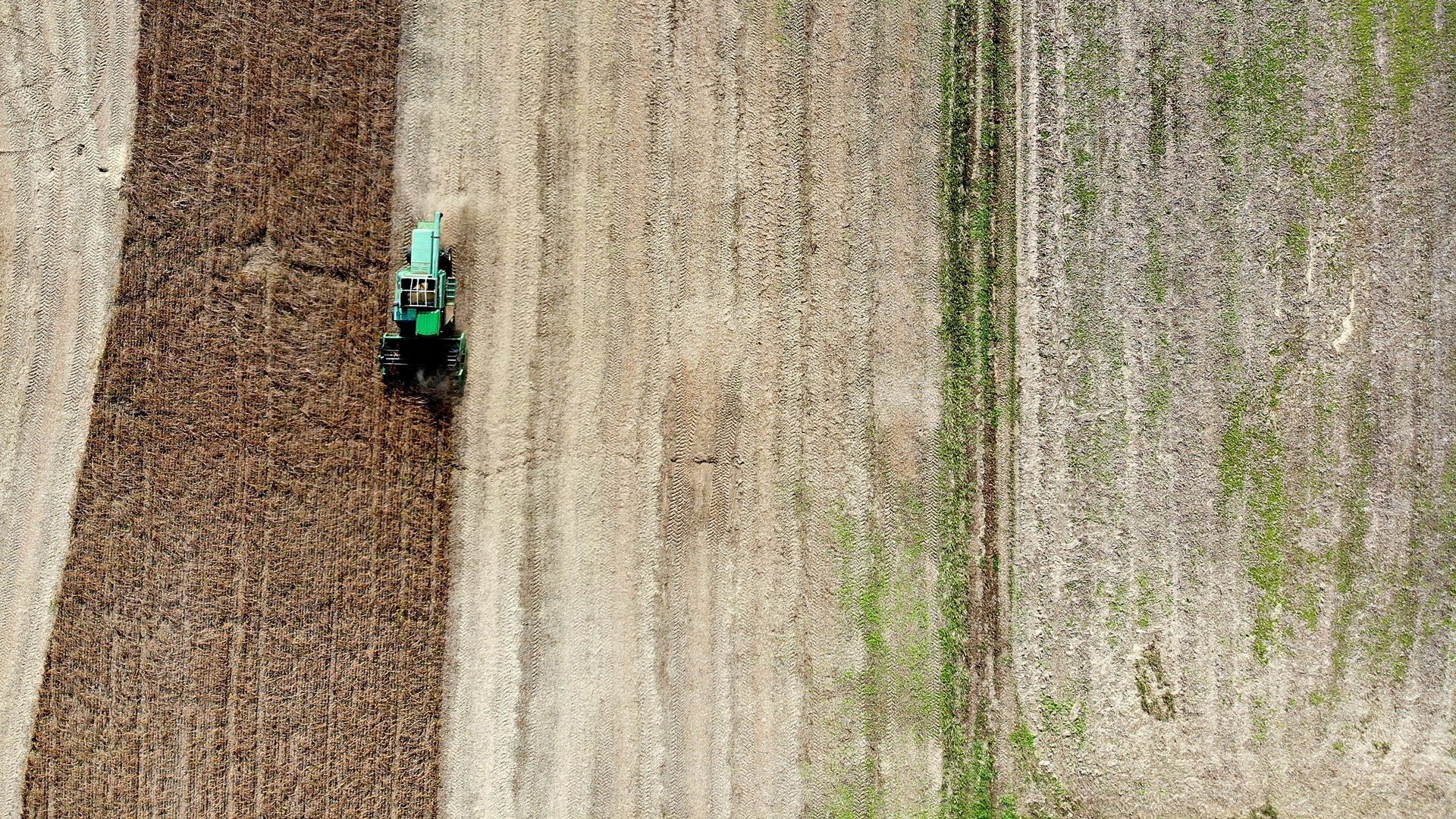 Photo of tractor plowing a soybean field in the U.S.