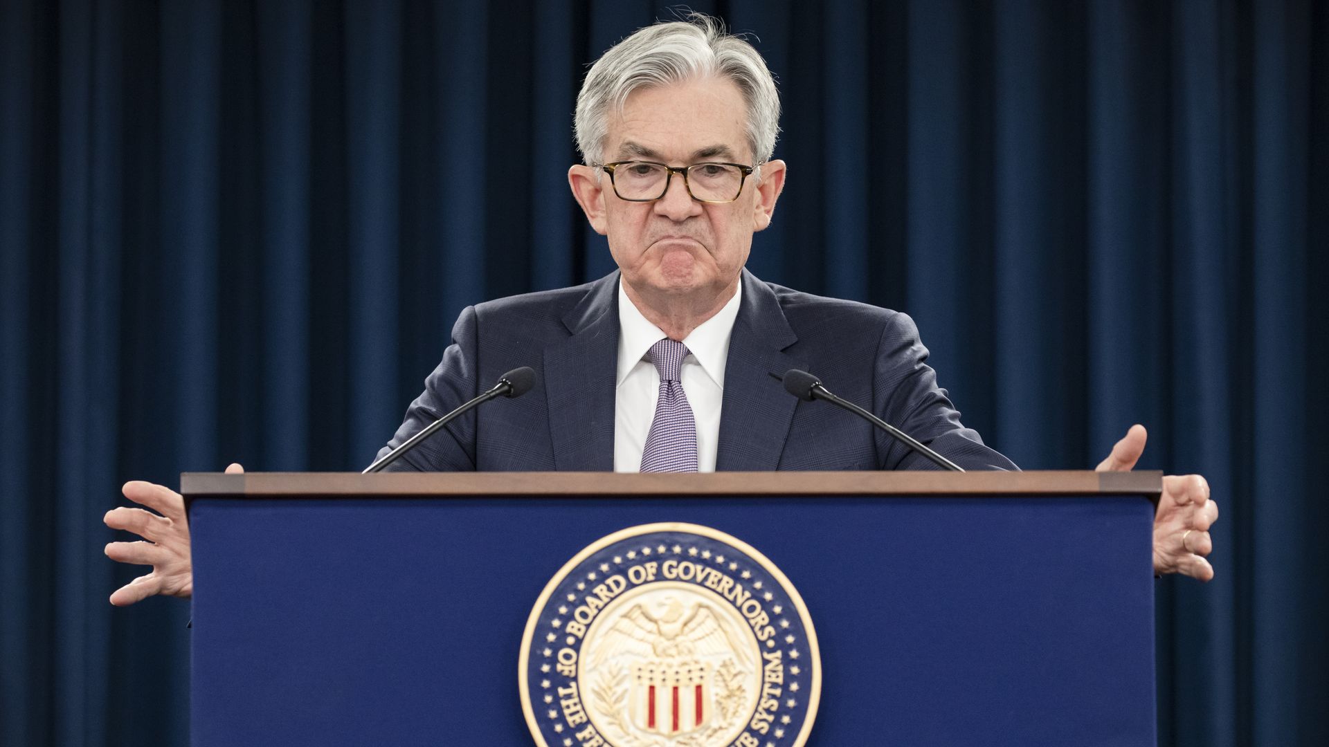 A photo of Fed chair Jerome Powell with his arms extended to flex on his haters.
